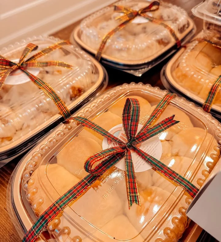 Festively packaged dinner rolls in takeout containers