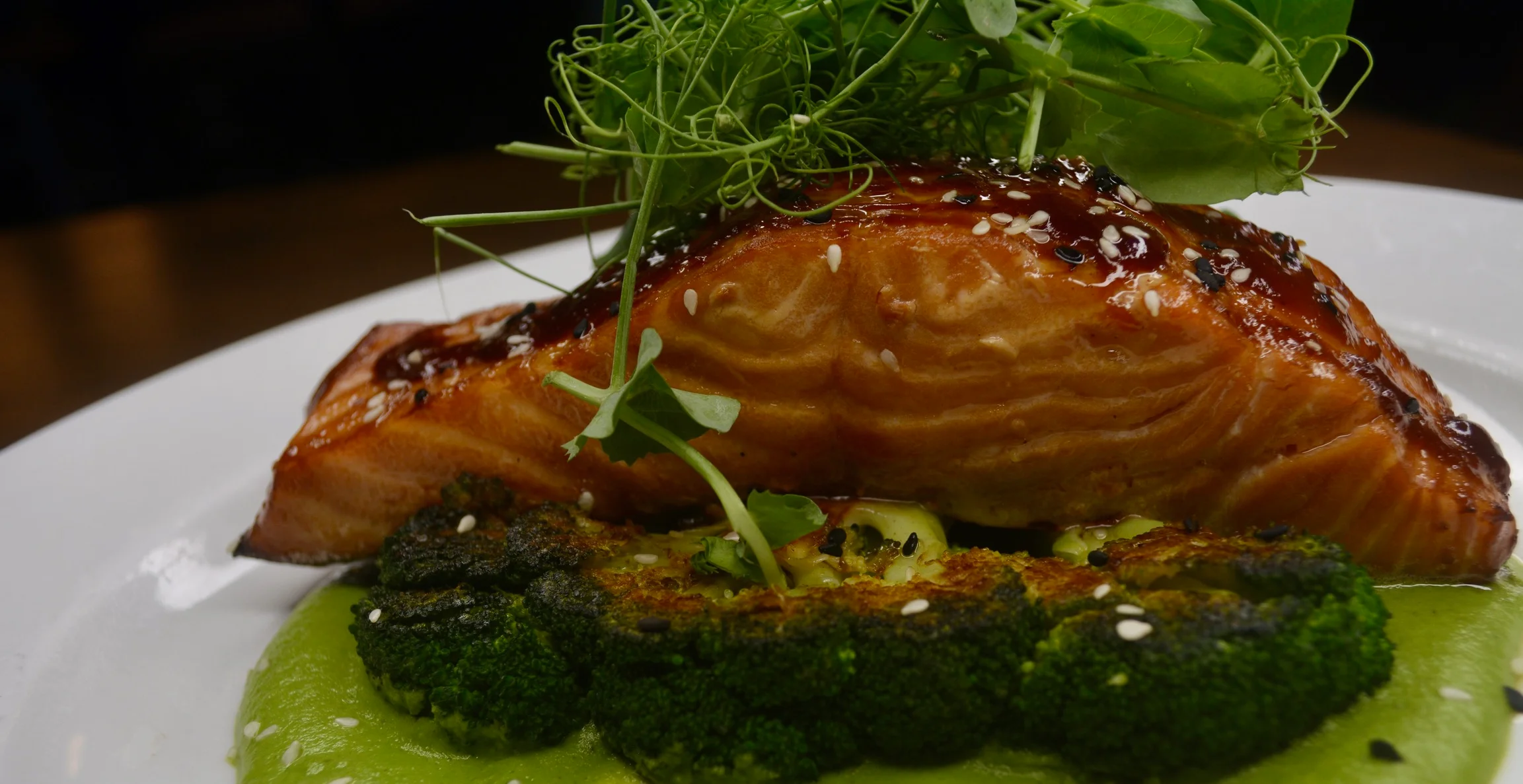 Grilled salmon with green pea puree, a modern American dish
