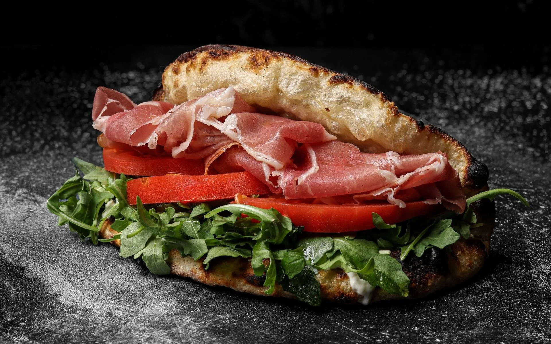 Italian prosciutto sandwich with arugula and tomatoes