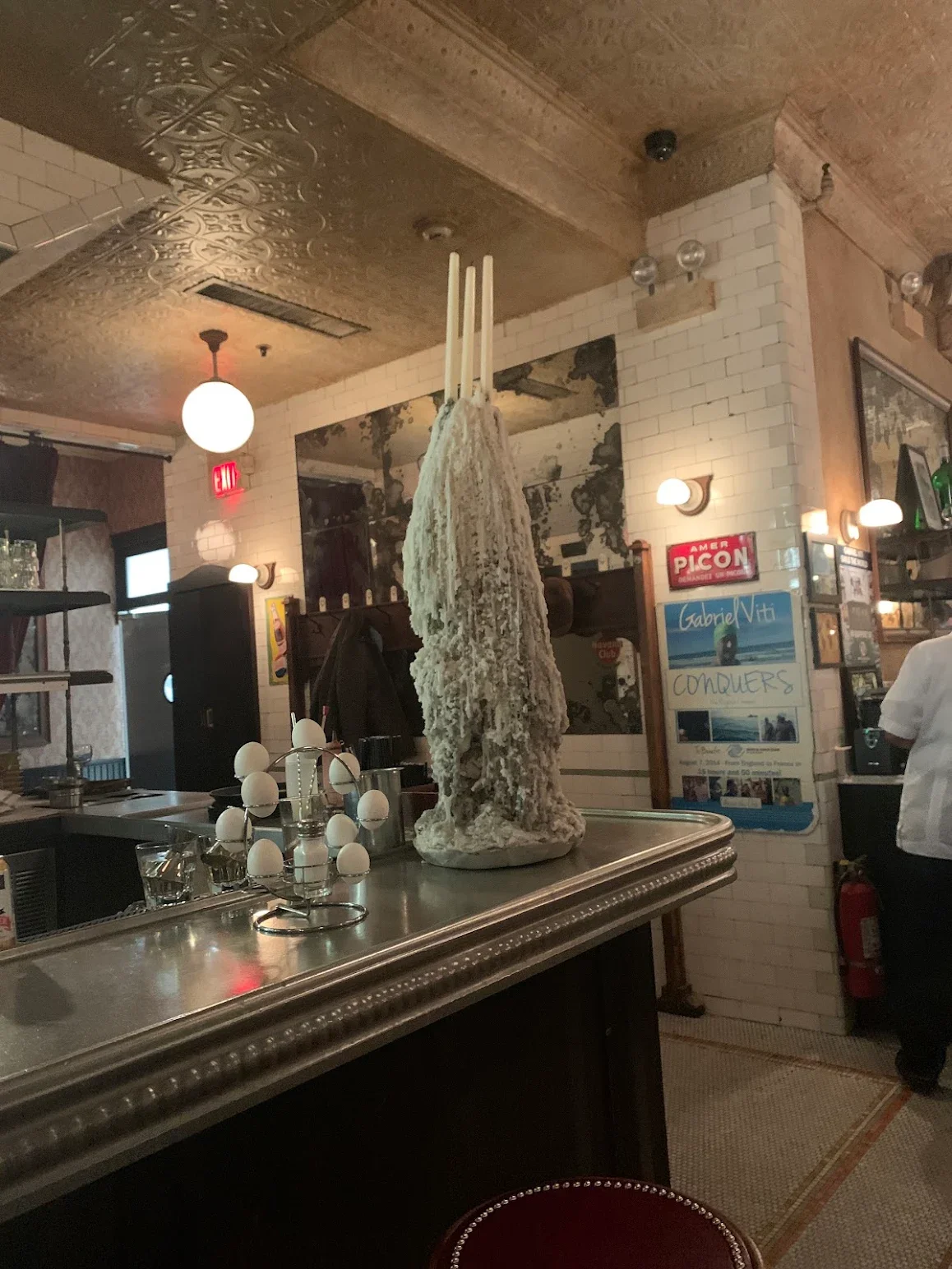 Unique bar decor featuring a sculptural centerpiece with candles