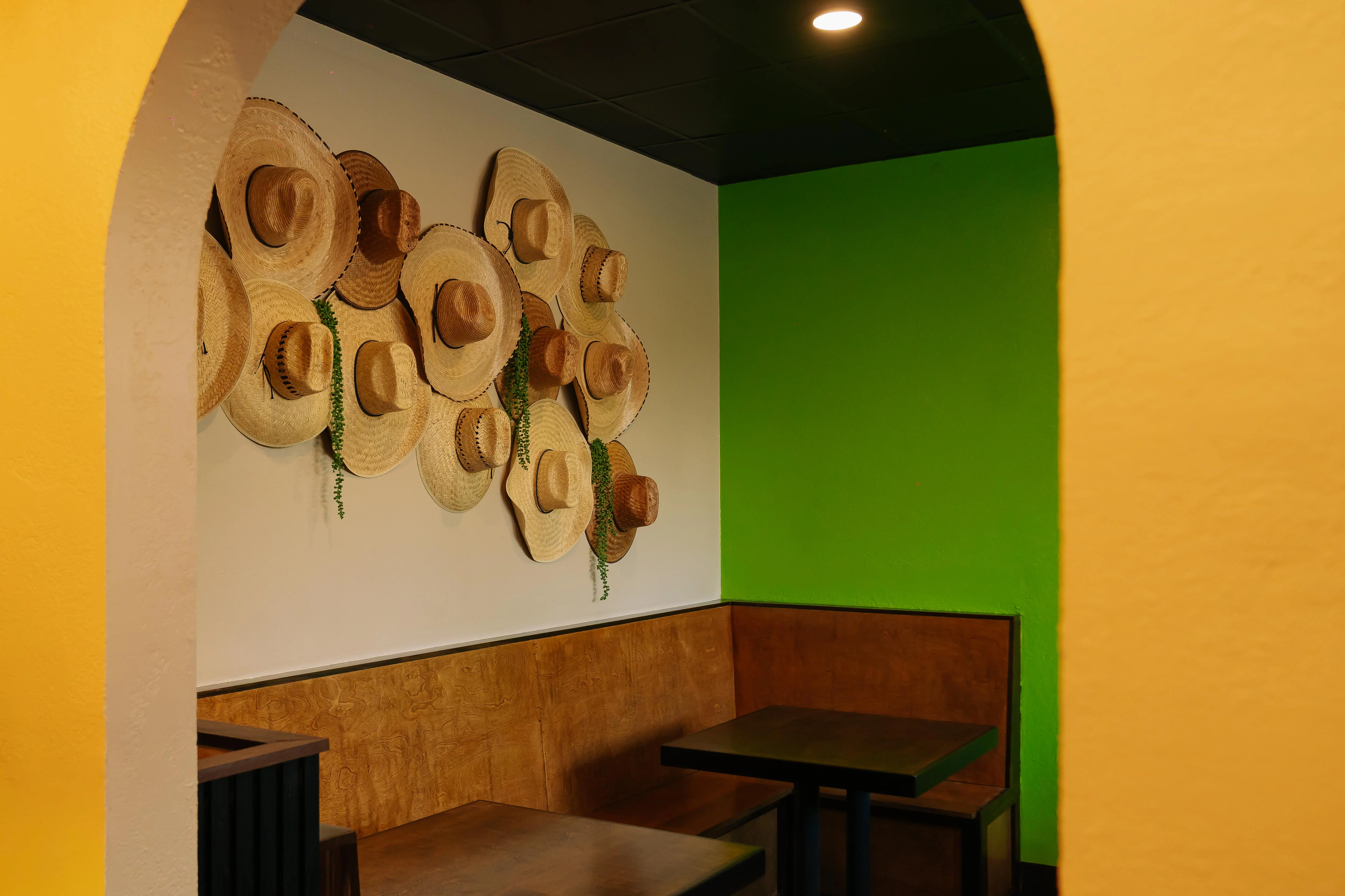 Colorful restaurant interior with decorative straw hats