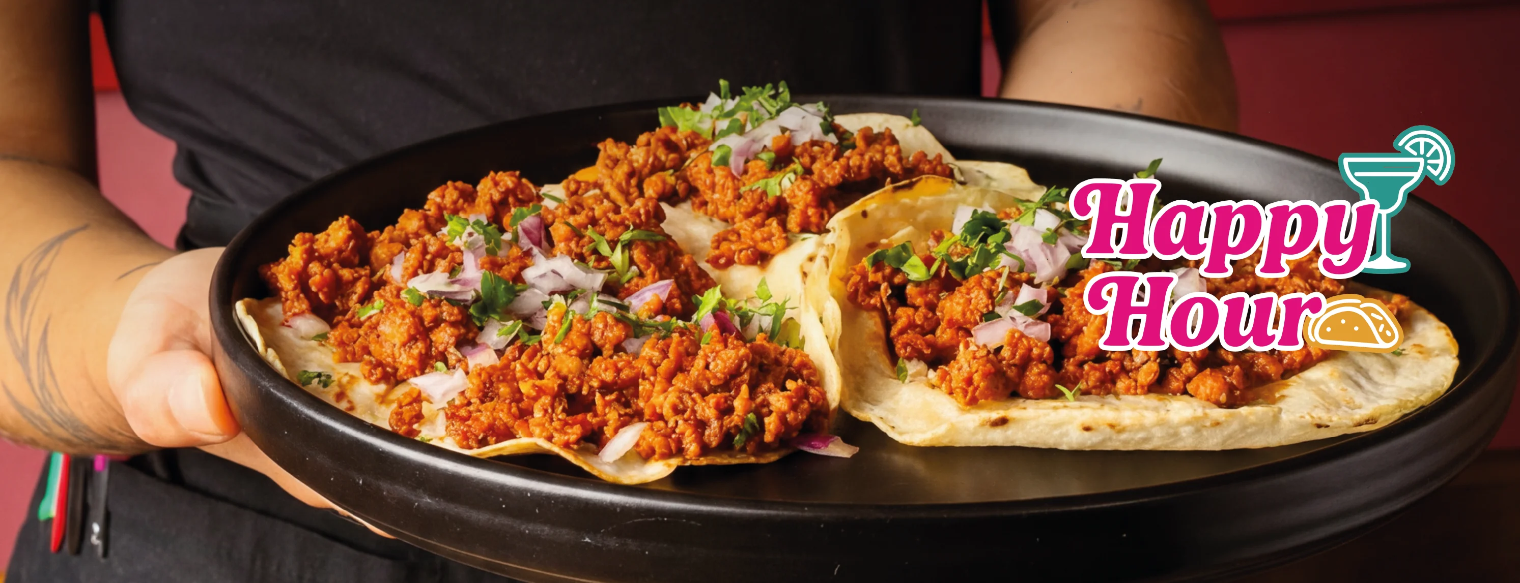 Plate of tacos with seasoned meat, onions, and cilantro, promoting Happy Hour.