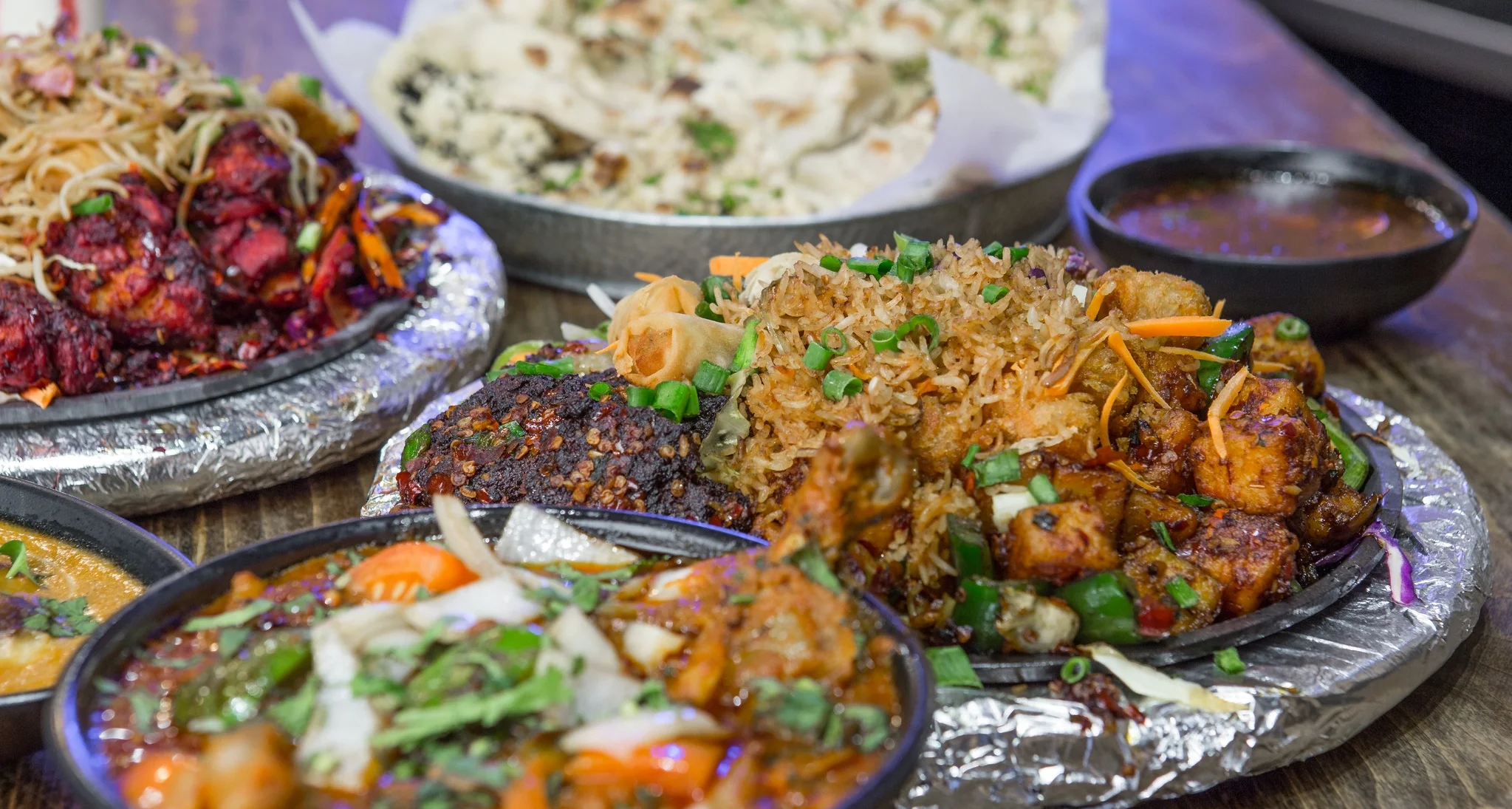 Indian mixed platter with biryani, chicken, and curry