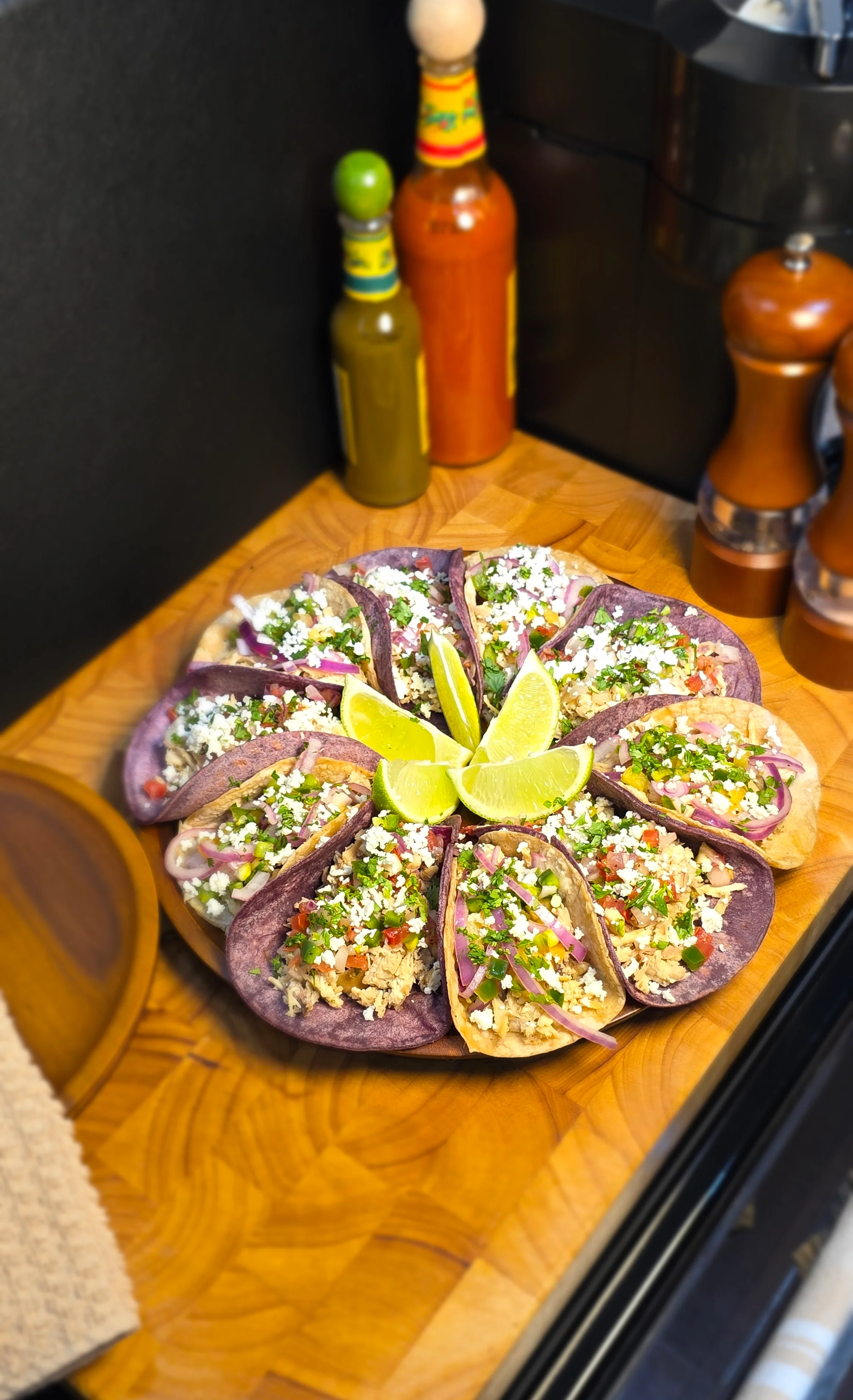 Colorful platter of Mexican tacos with lime wedges
