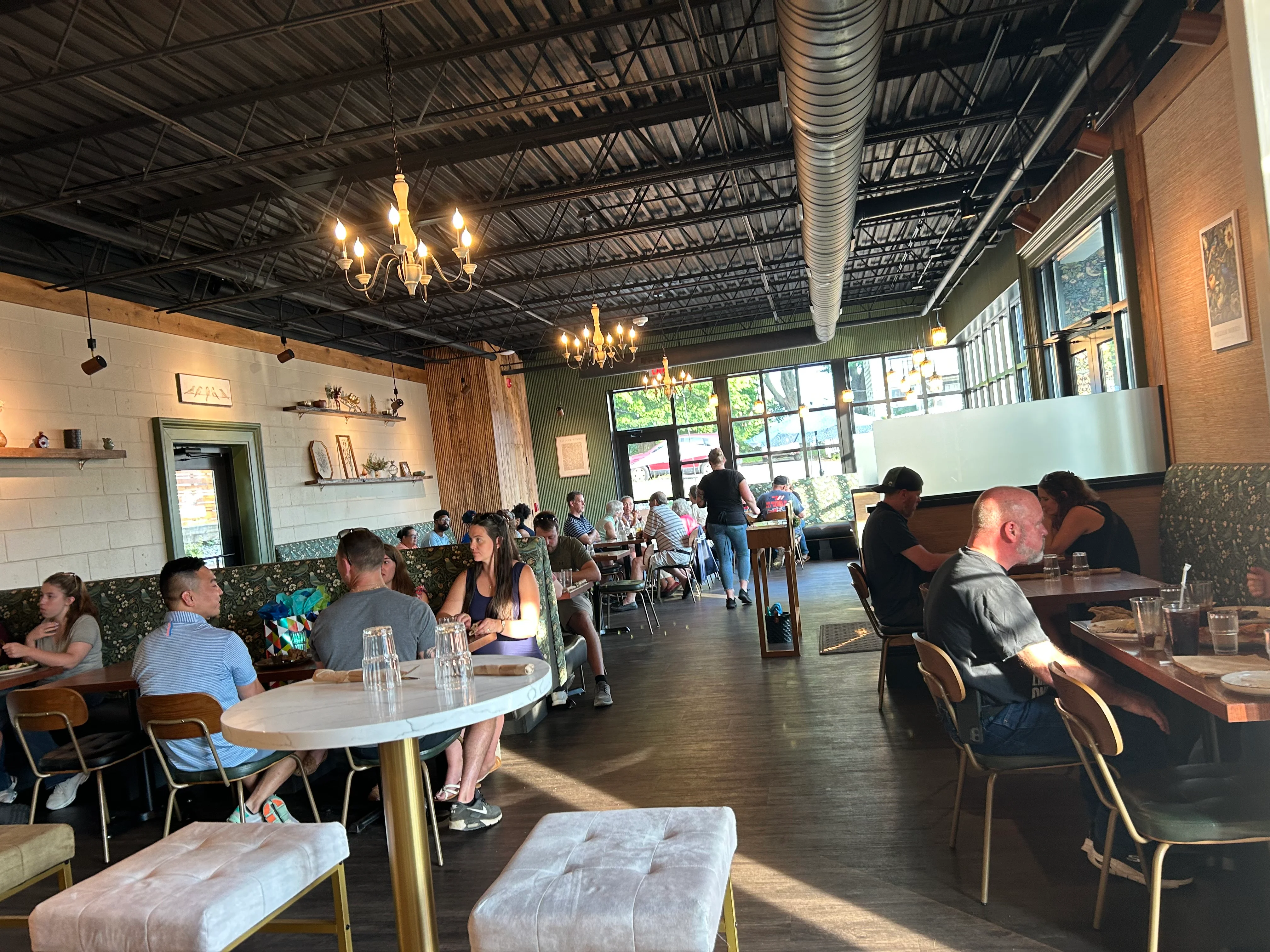 Cozy restaurant interior with warm lighting and patrons dining