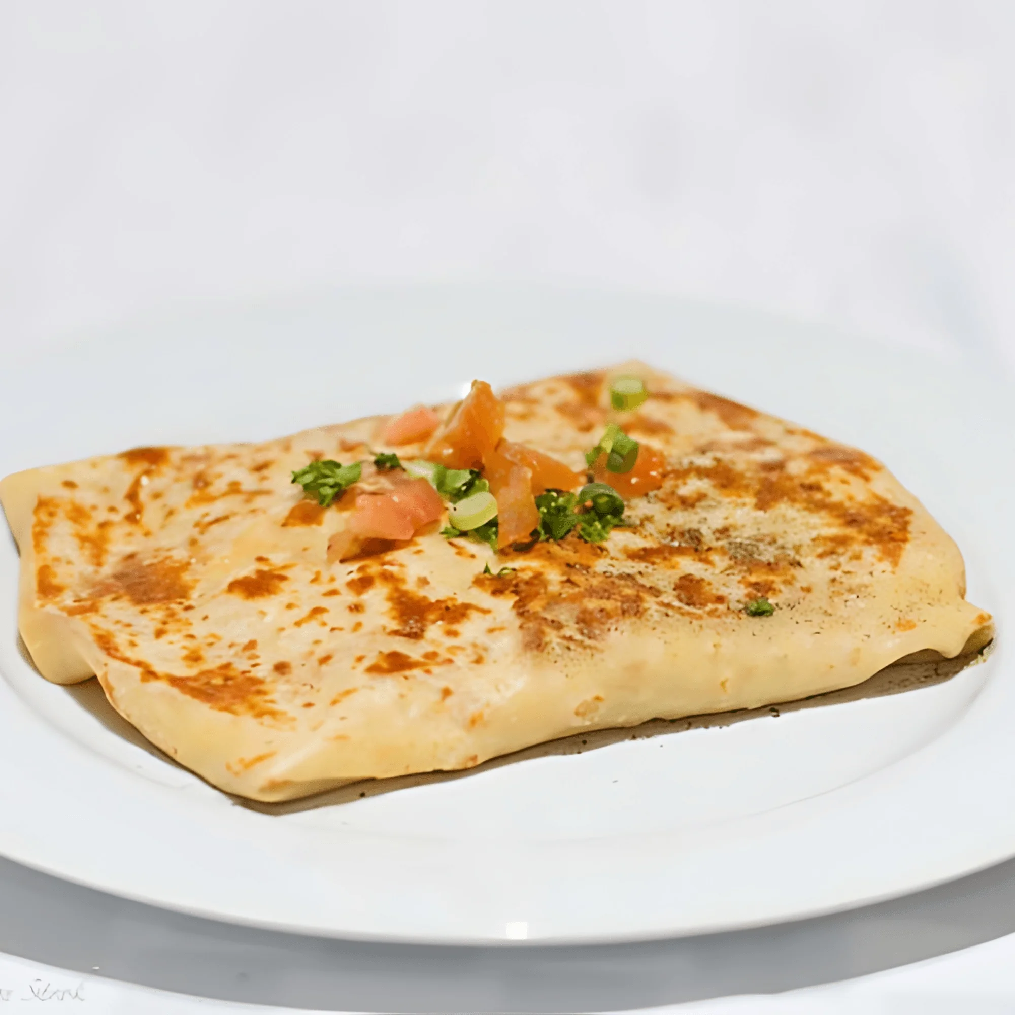 Savory Indian paratha topped with fresh herbs and tomatoes