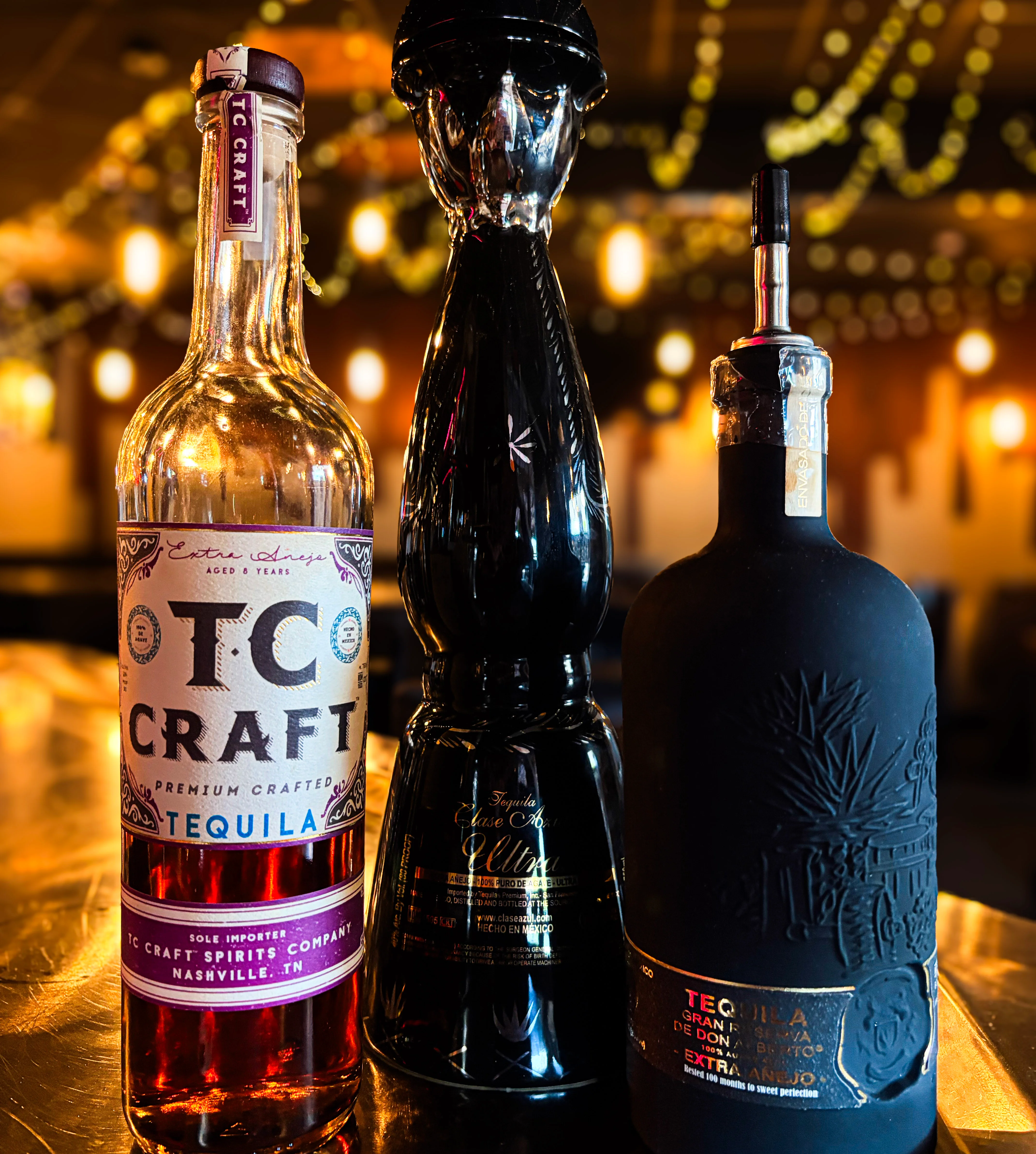 Selection of premium añejo tequilas on a bar counter