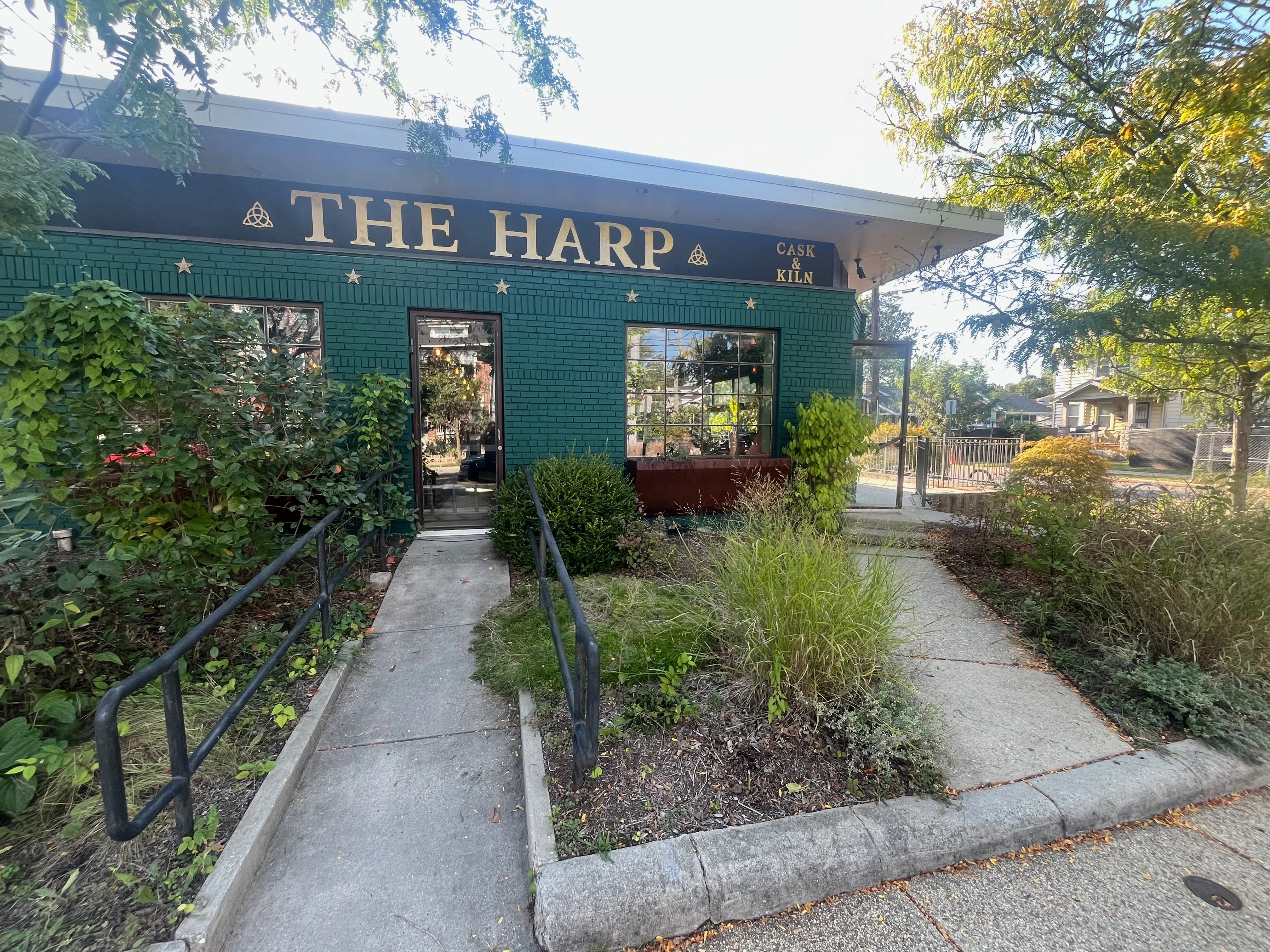 Exterior view of The Harp restaurant with green brick facade
