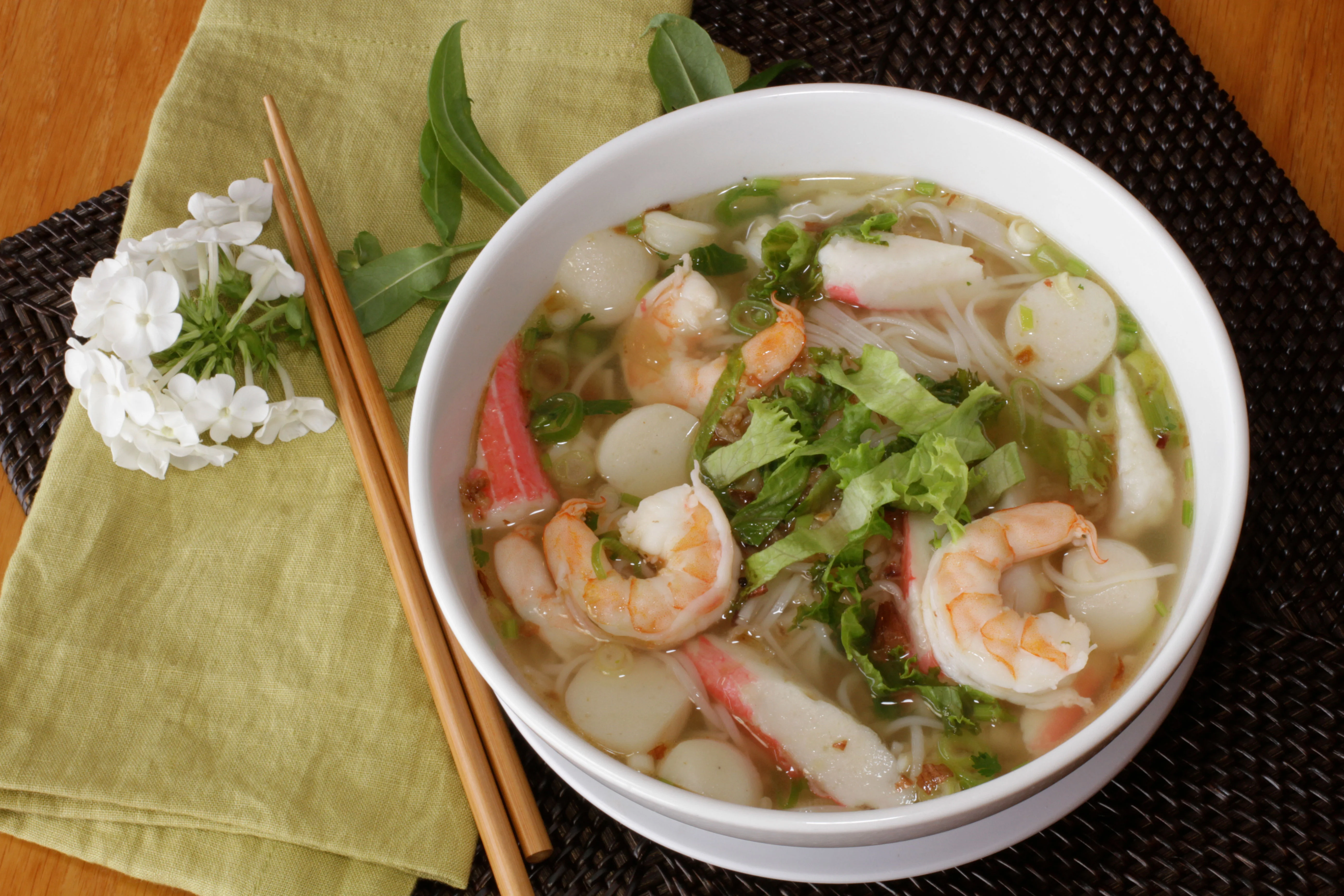 Bowl of Vietnamese seafood pho with fresh herbs