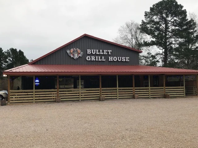 Exterior view of Bullet Grill House restaurant with rustic charm