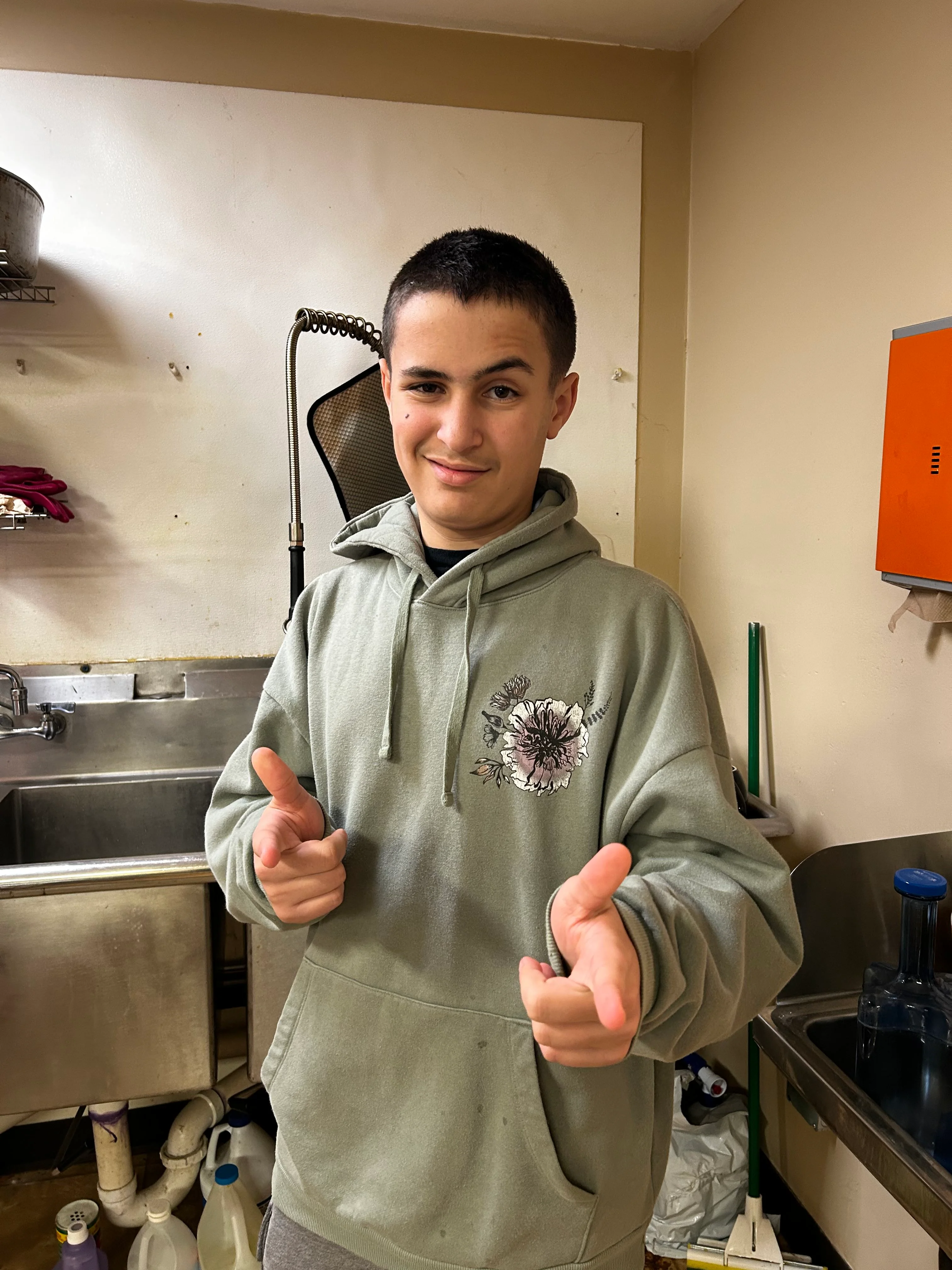 Young person playfully posing in a restaurant kitchen