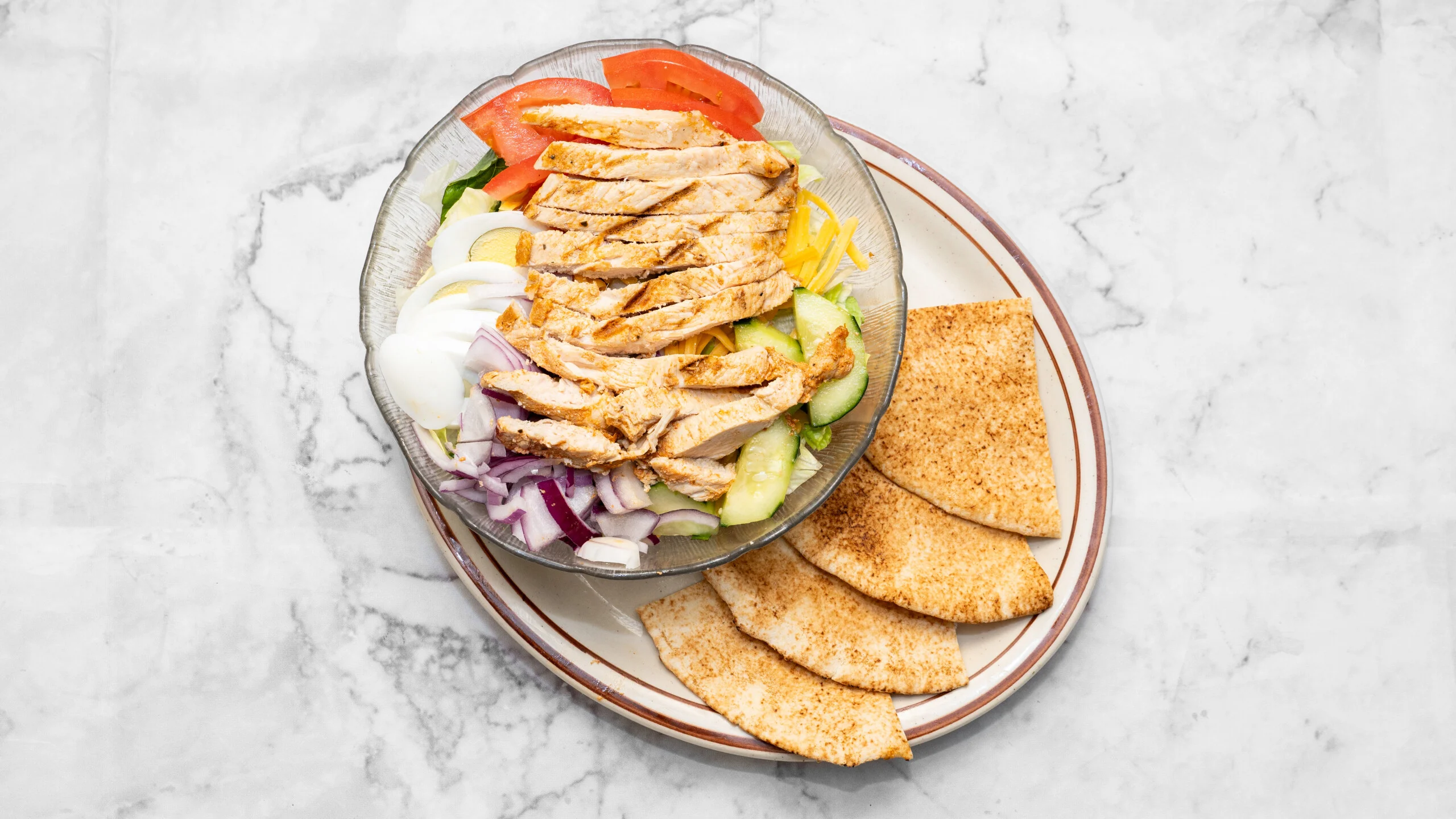 Grilled chicken salad with fresh vegetables, a Mediterranean classic