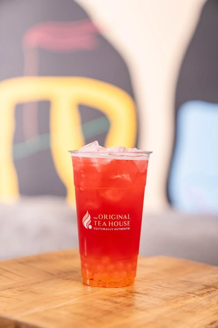 Refreshing fruit tea in a clear cup with ice