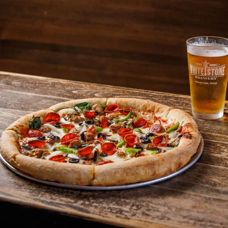 Delicious pizza with various toppings on a wooden table.