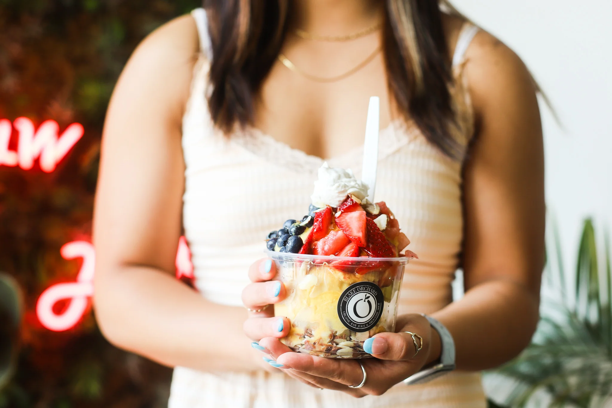 Colorful acai bowl topped with fresh fruits and whipped cream