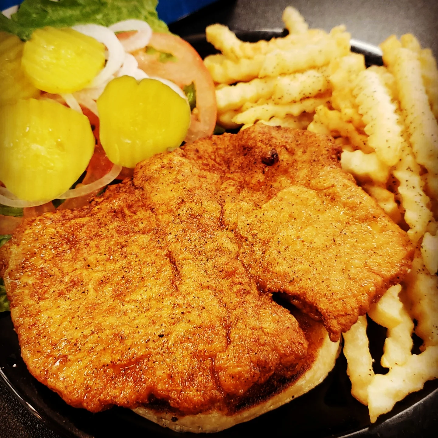 Southern fried chicken sandwich with pickles and crinkle fries