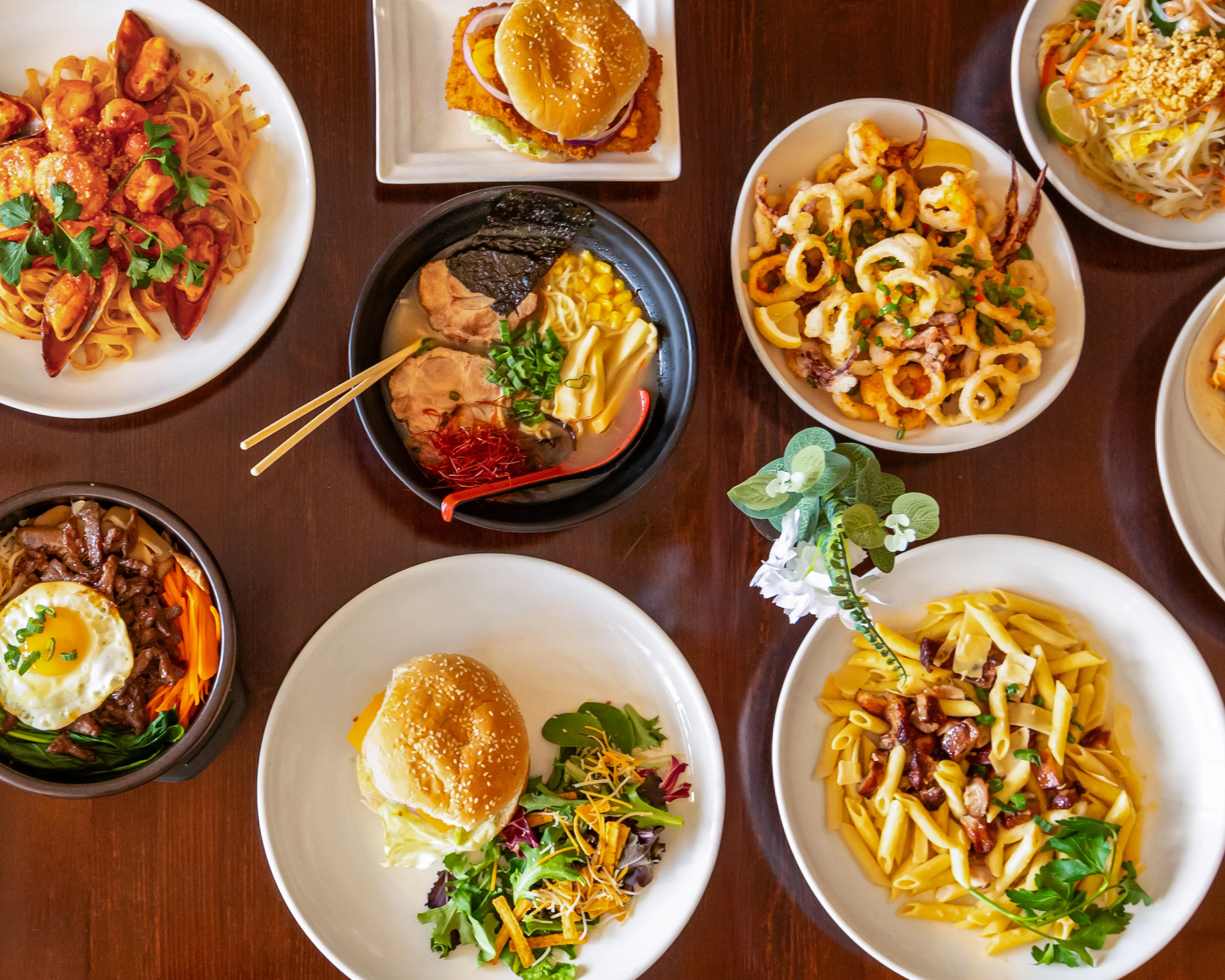 Variety of Asian fusion dishes including ramen and stir-fried noodles