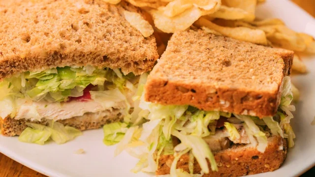Classic American turkey sandwich with lettuce and chips