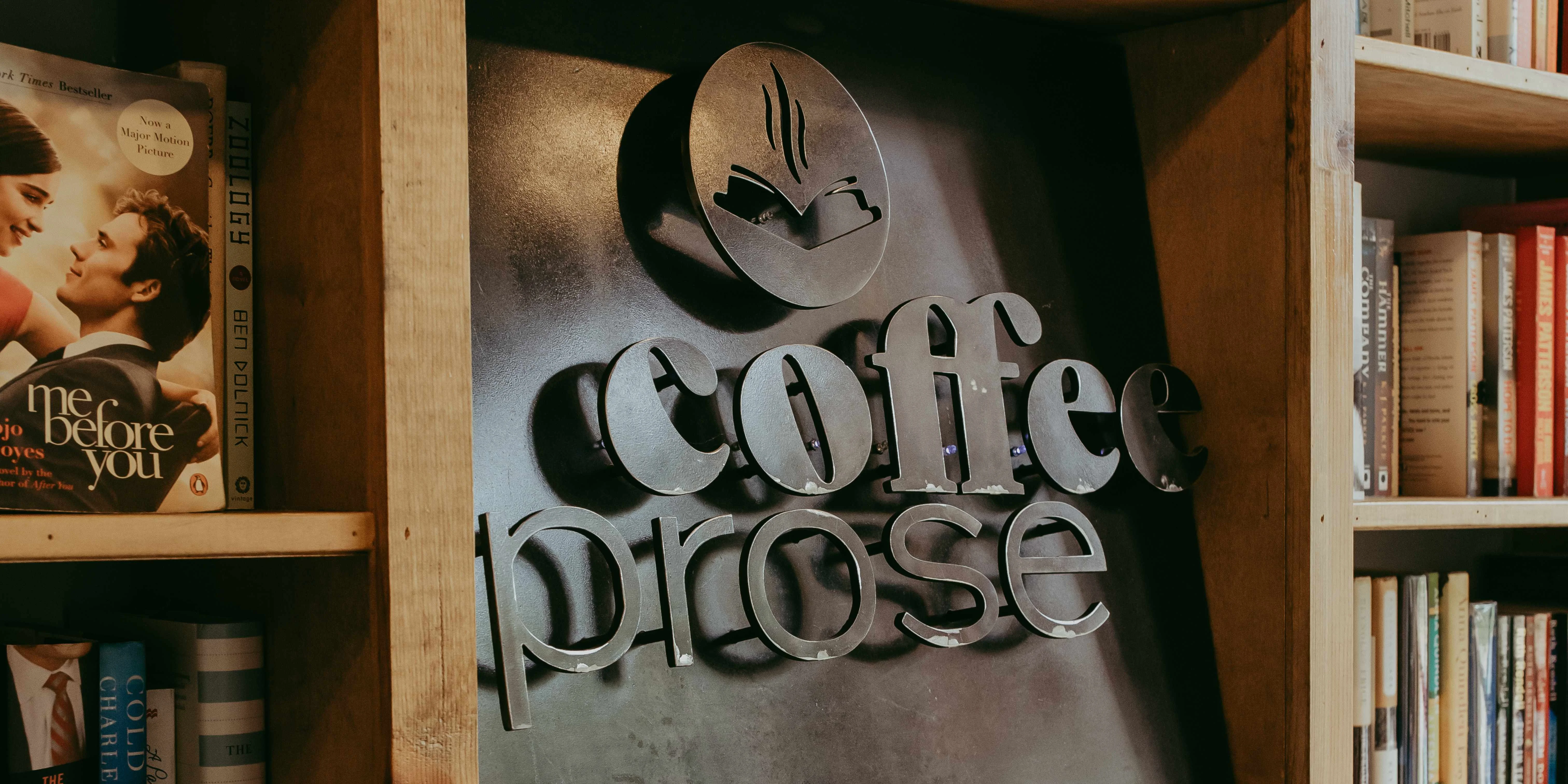 Cozy coffee shop sign with bookshelves in the background
