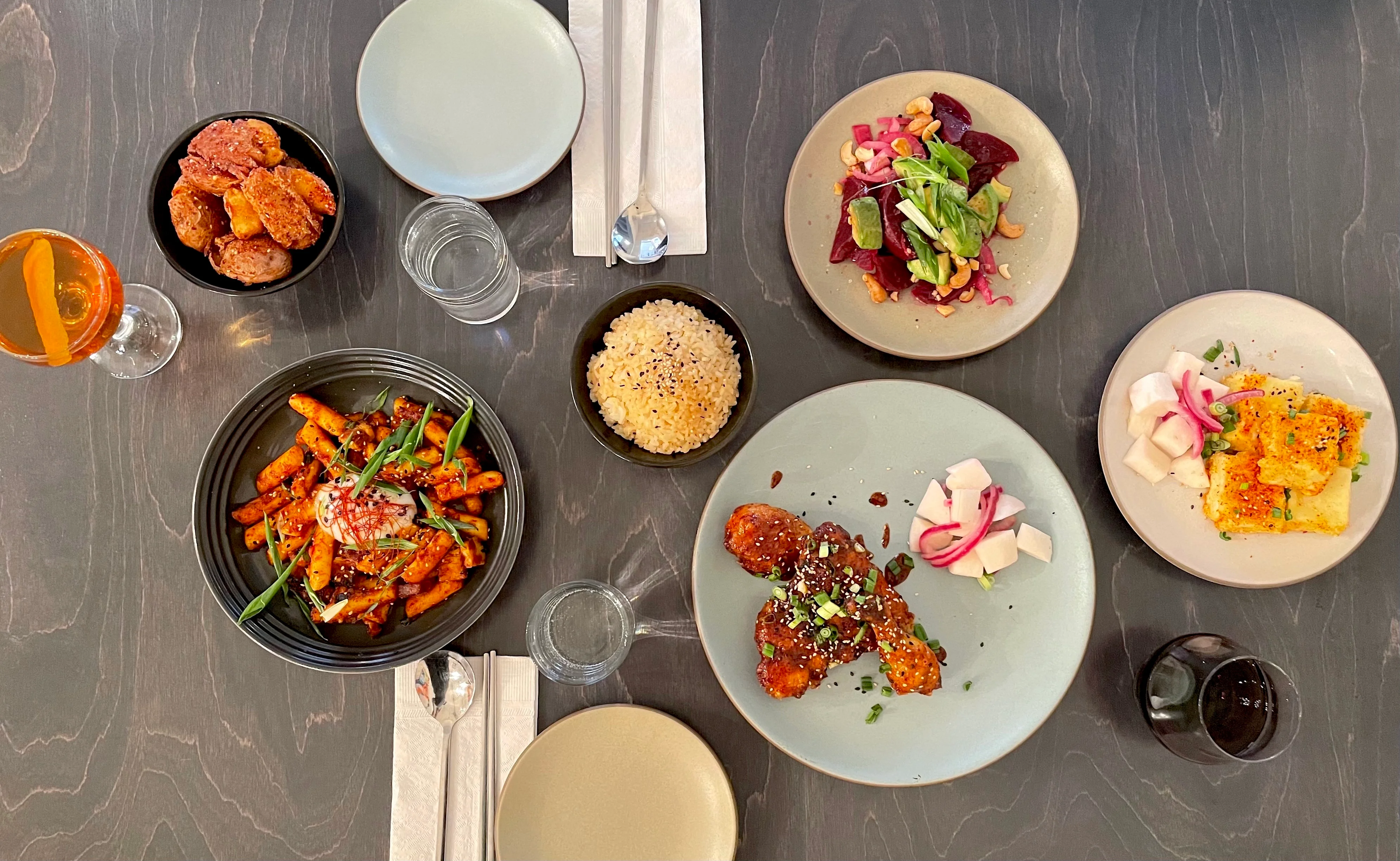 A bunch of banchan and tteokbokki 