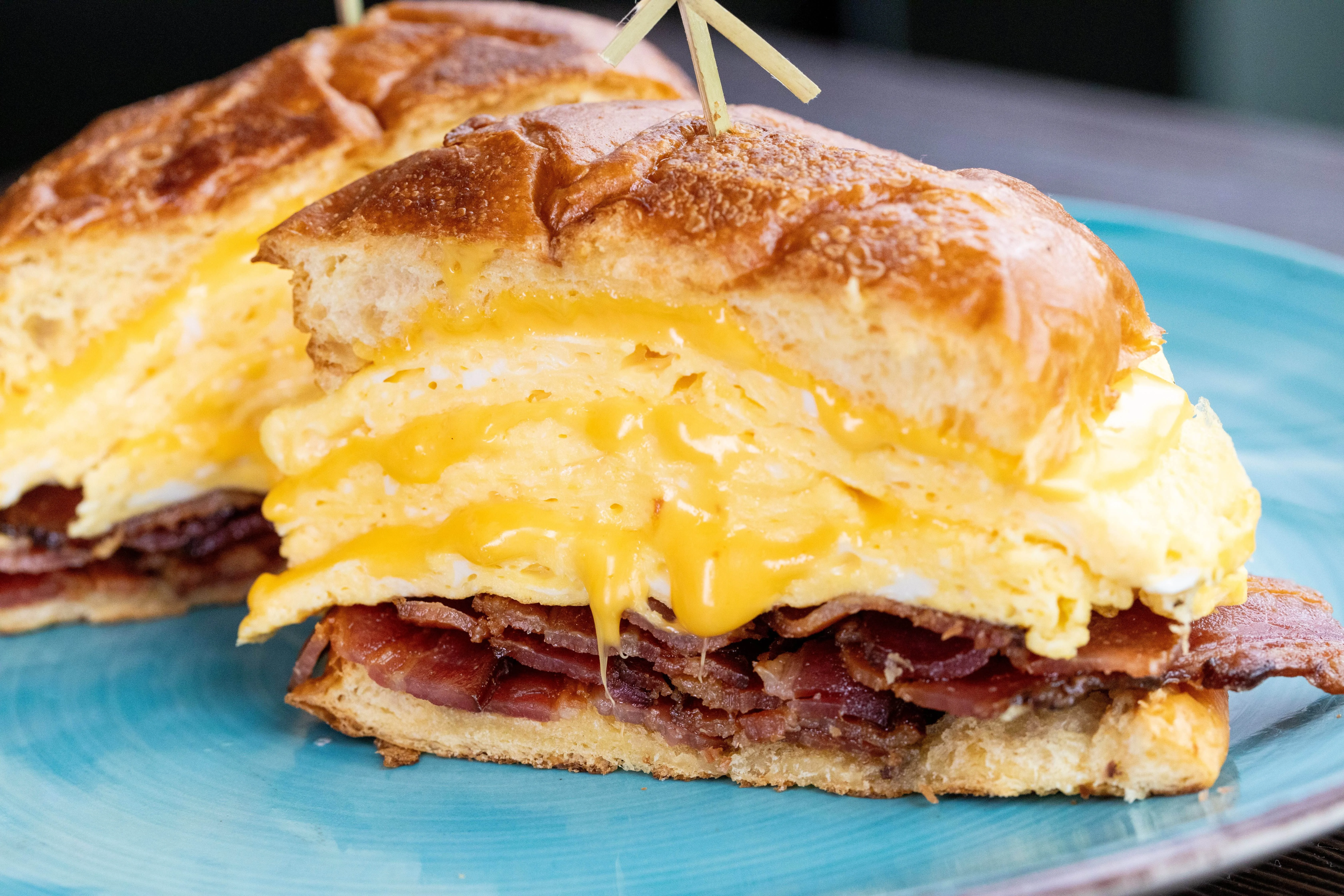 Savory breakfast sandwich with eggs and cheese on a brioche bun