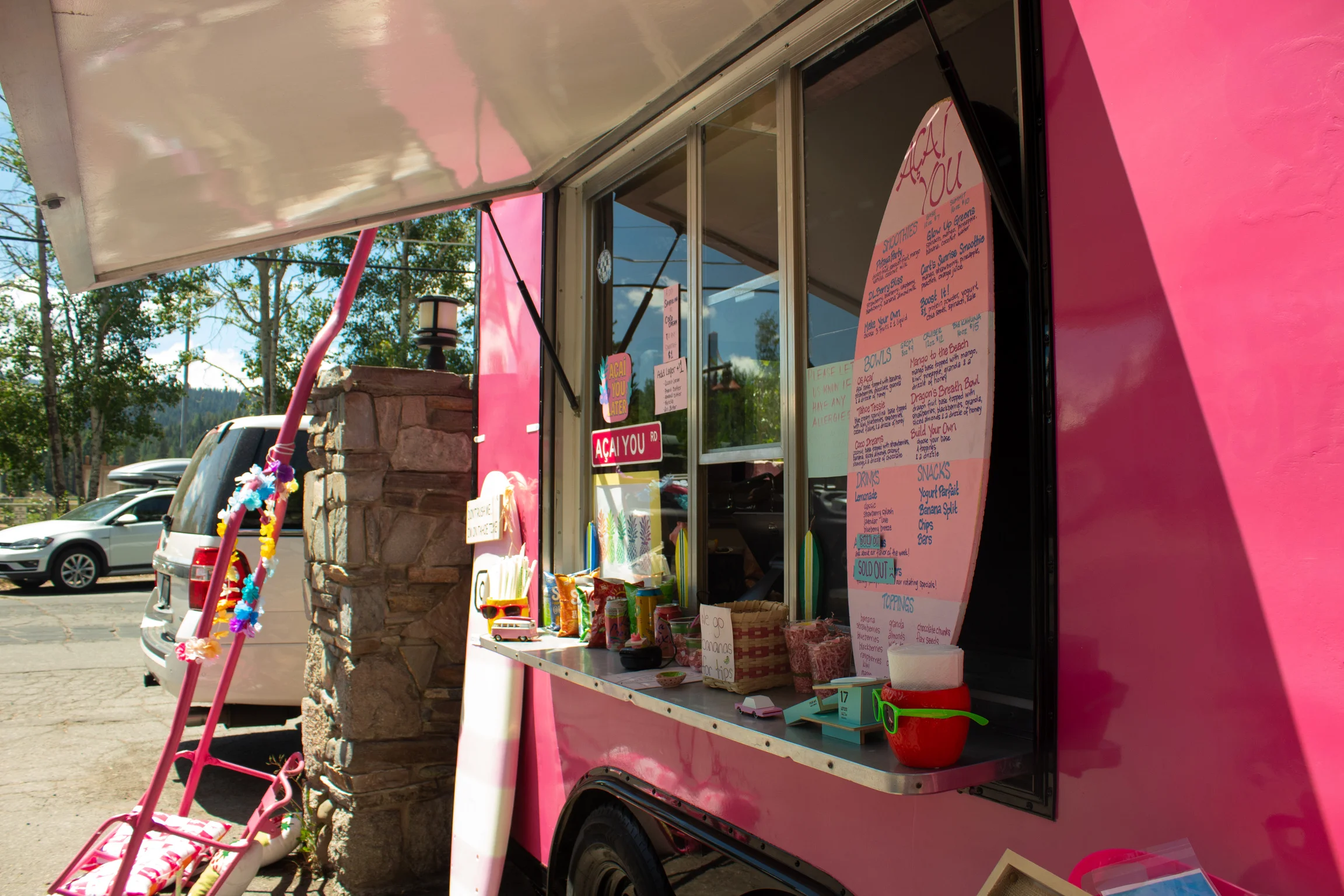 Colorful food truck serving acai bowls and snacks