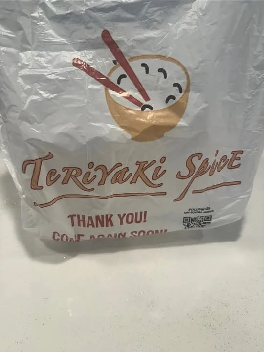 A takeout bag featuring a bowl with chopsticks and the name 'Teriyaki Spice', conveying a thank-you message.