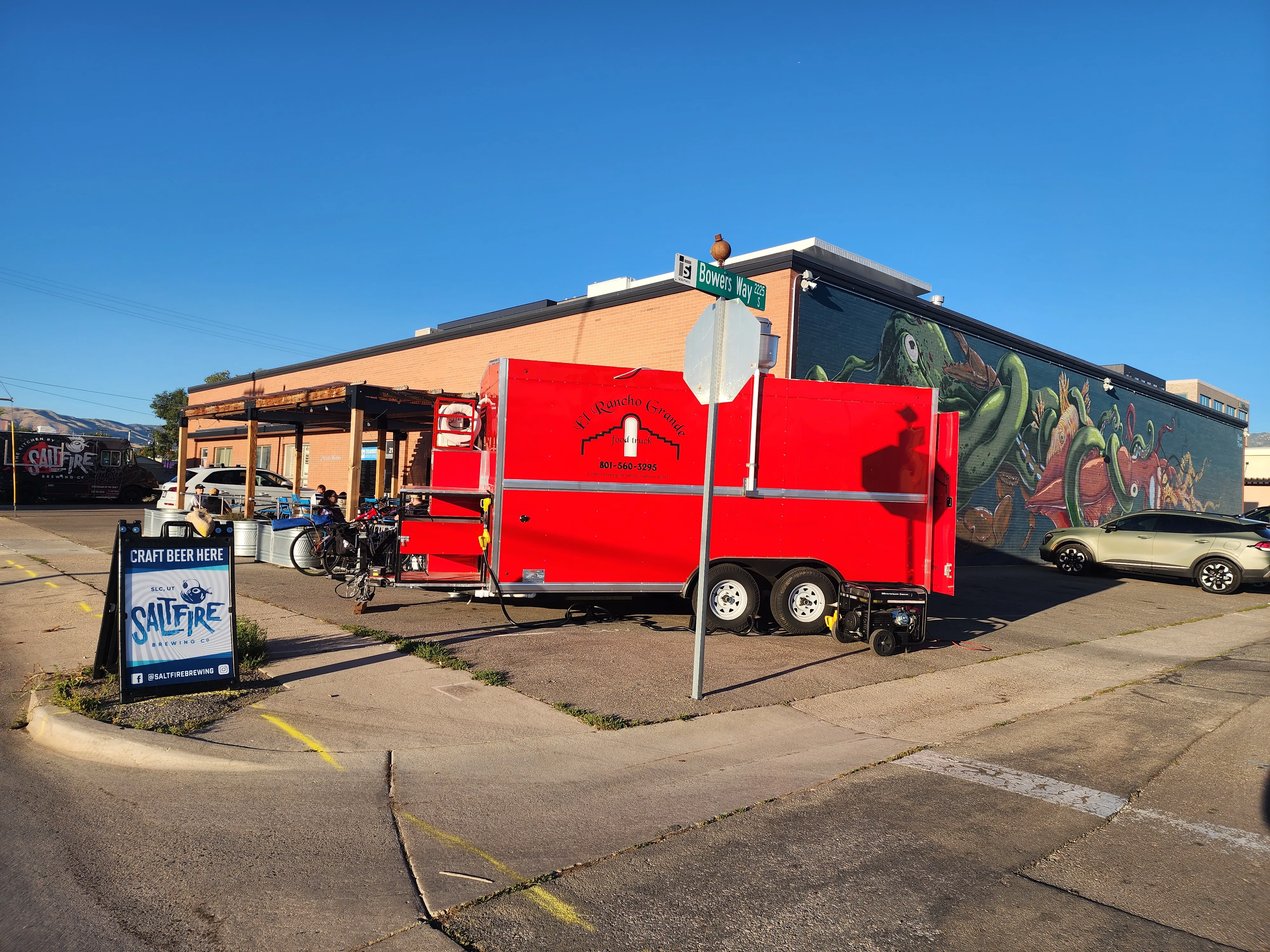 Food truck serving craft beer outside a vibrant mural
