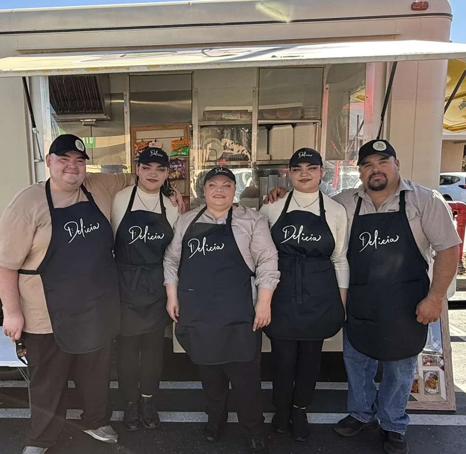 Food truck team serving delicious street tacos