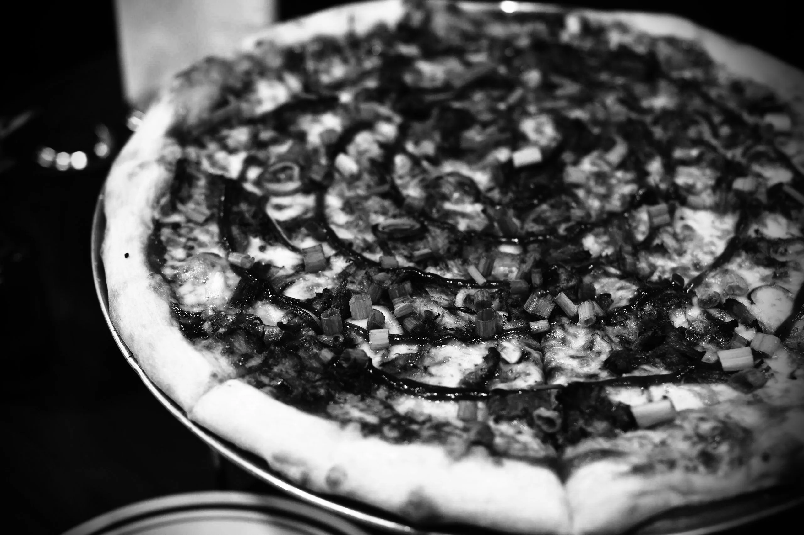 Close-up of a loaded Italian-style pizza on a plate