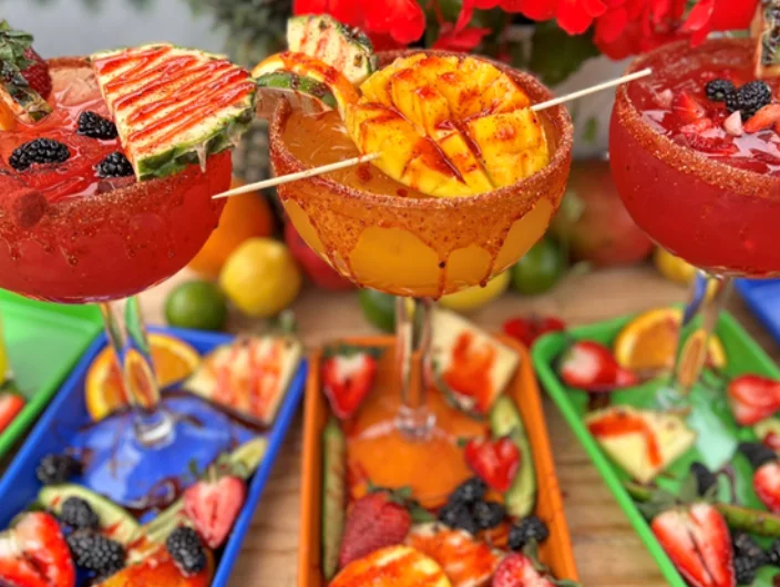 Colorful margaritas with fresh fruit garnishes
