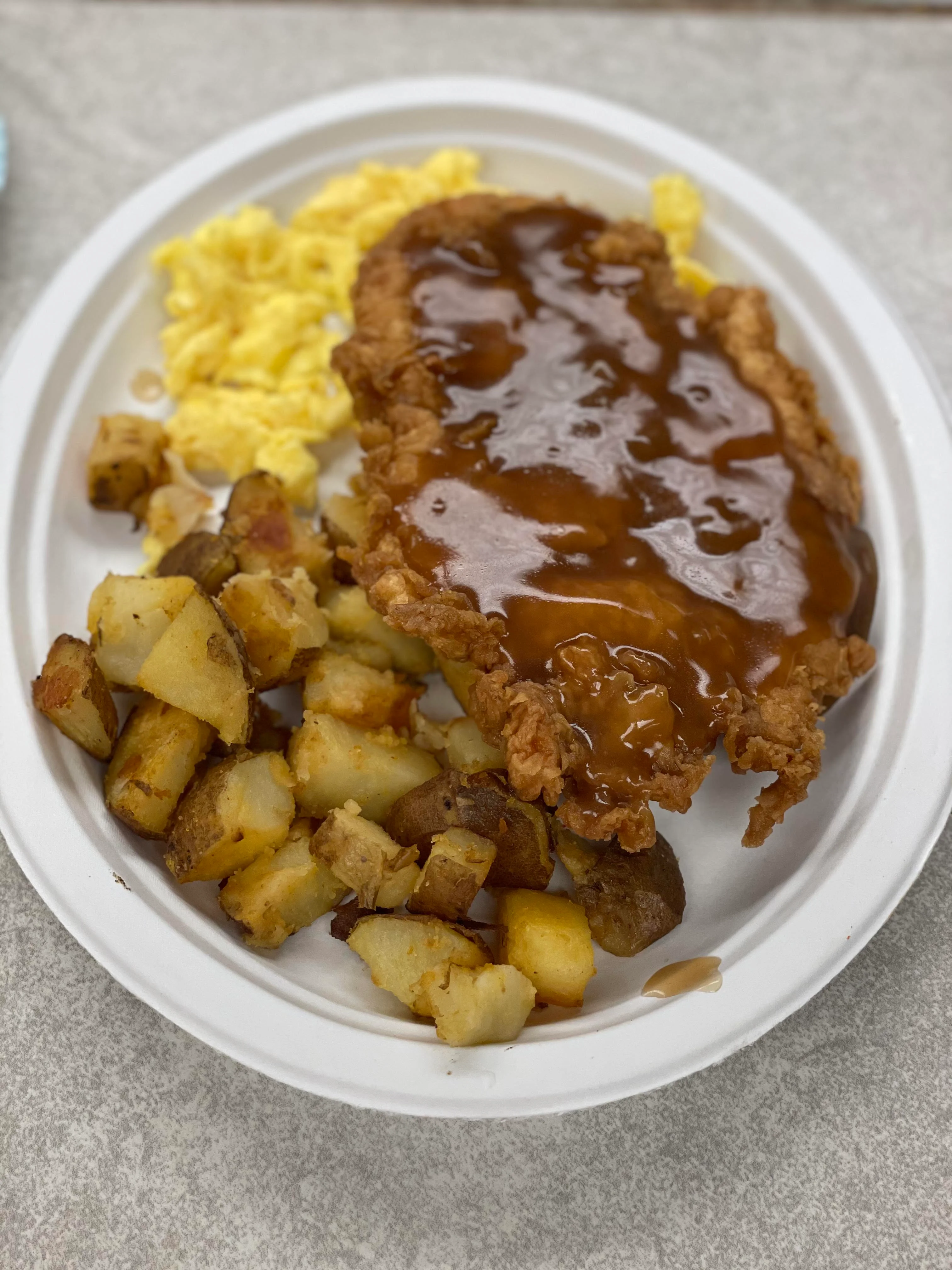 Southern chicken fried steak with gravy and scrambled eggs