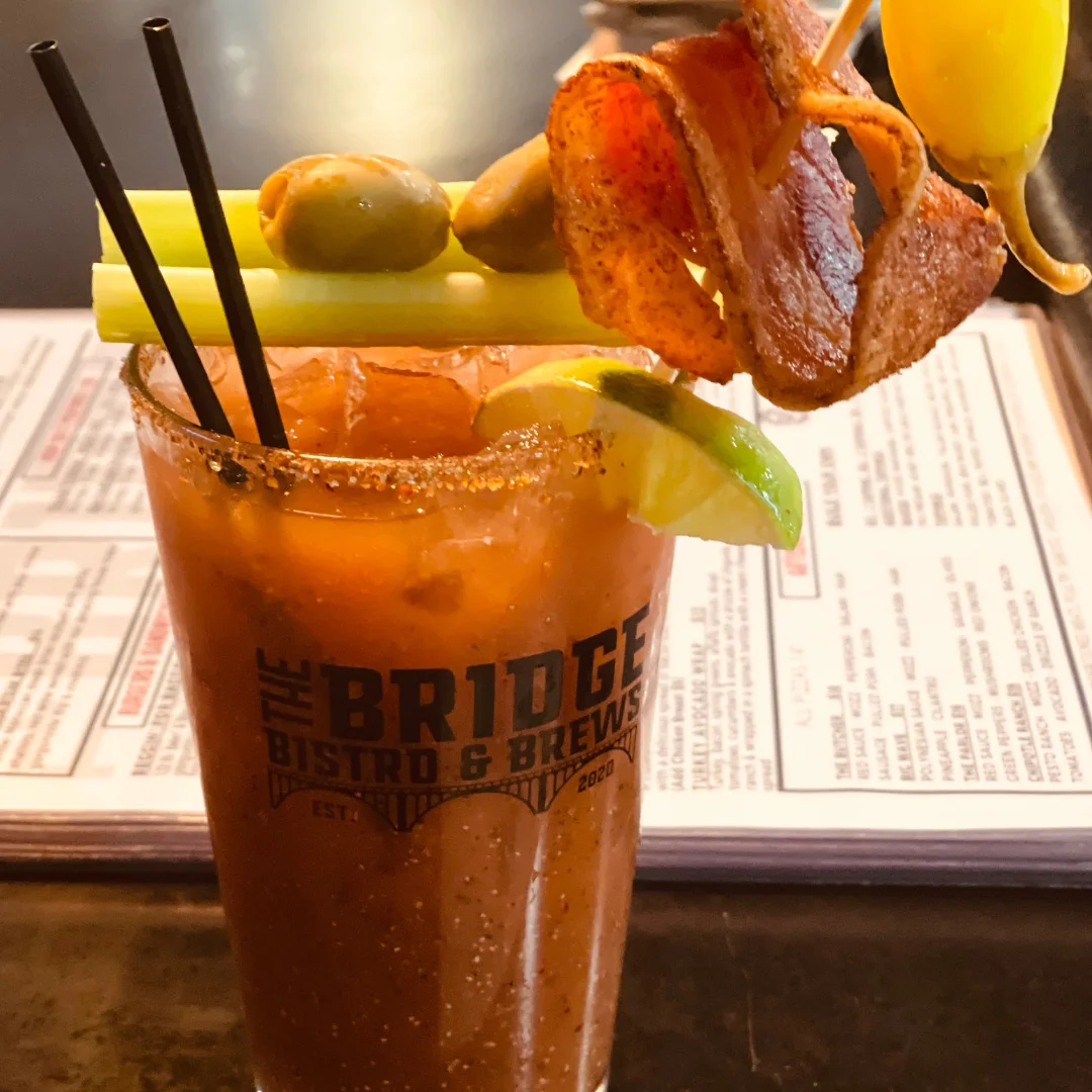 A vibrant cocktail and food spread on a table.
