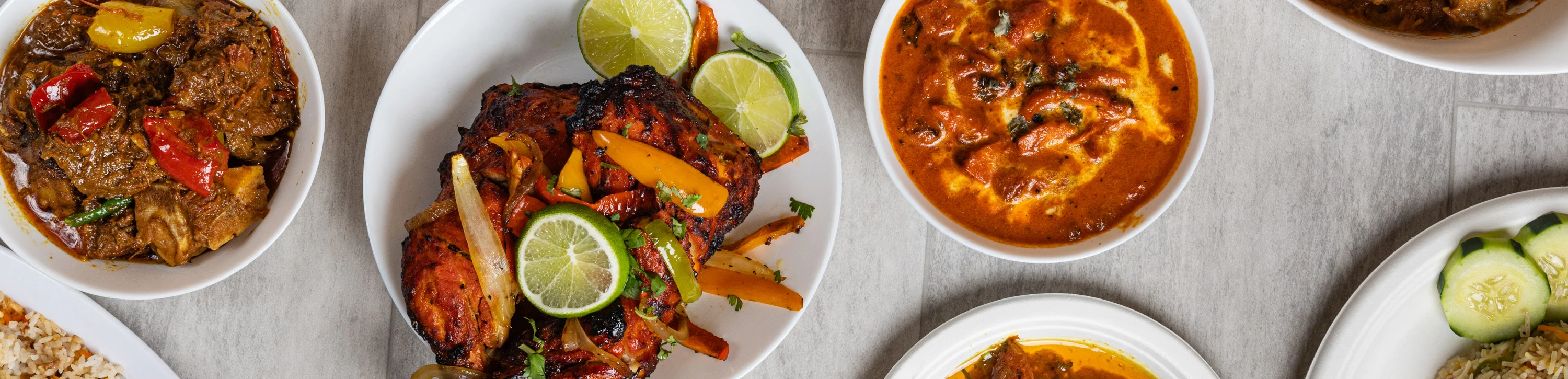 Assorted Indian curries and grilled chicken with rice dishes