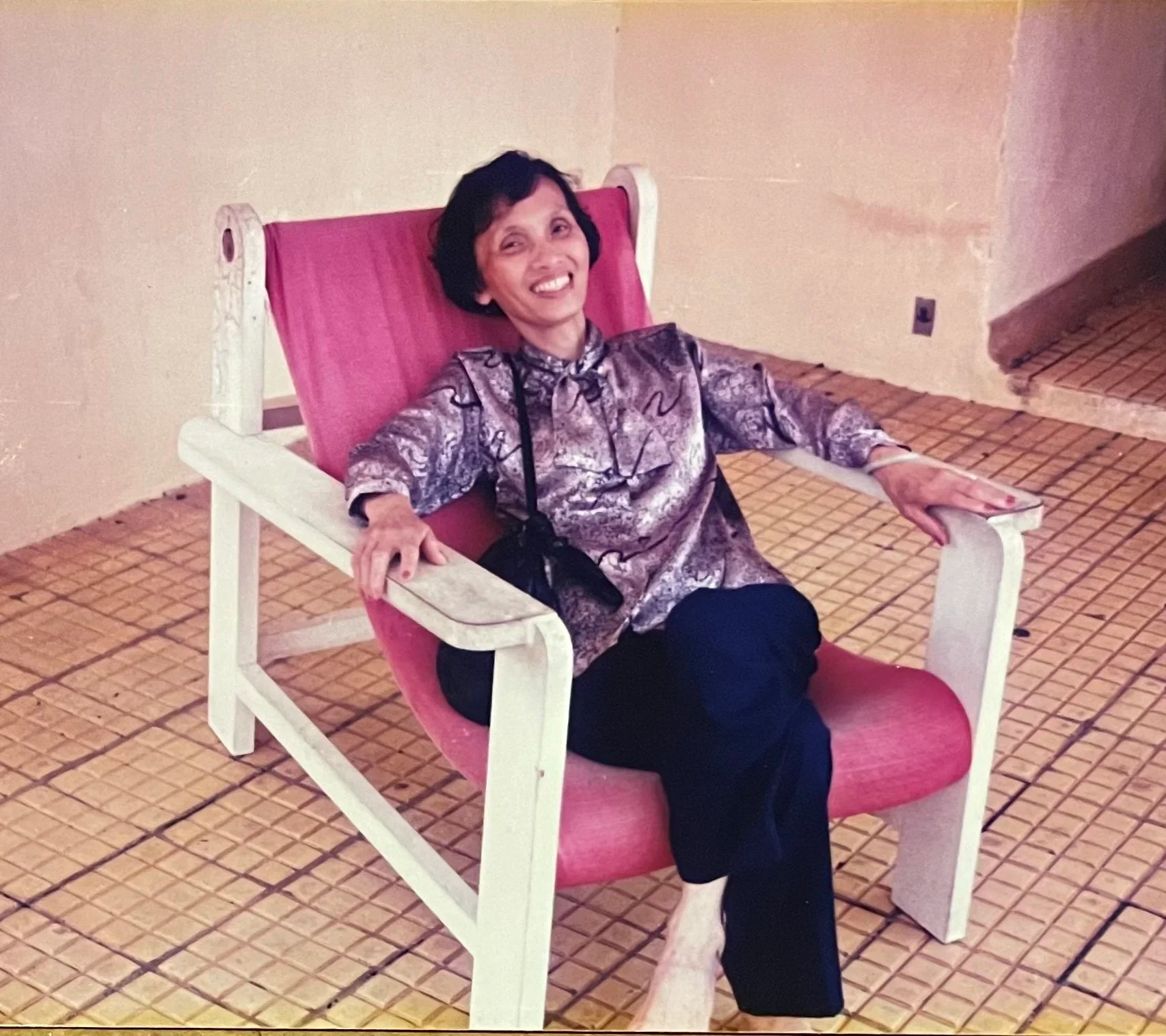 Smiling woman relaxing in a colorful chair