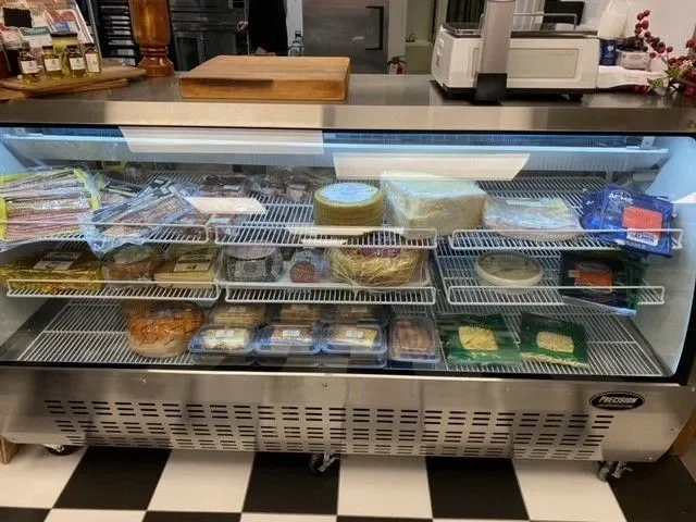 Chilled display case with assorted gourmet deli items