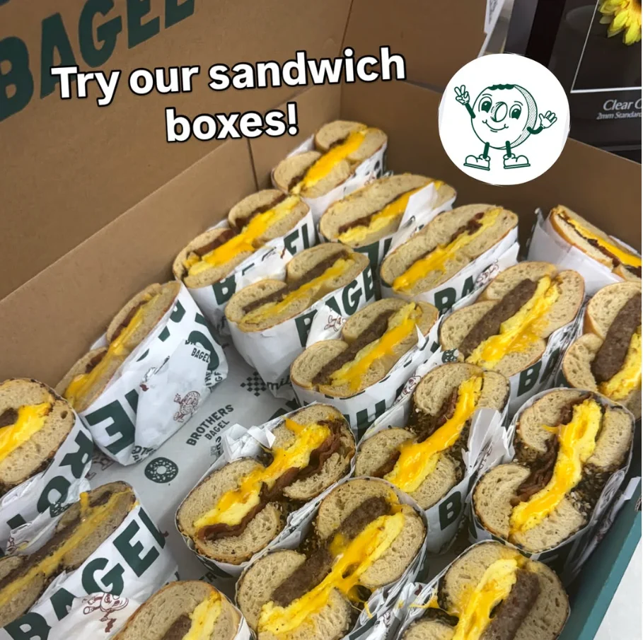 Box of bagel sandwiches with cheese and sausage