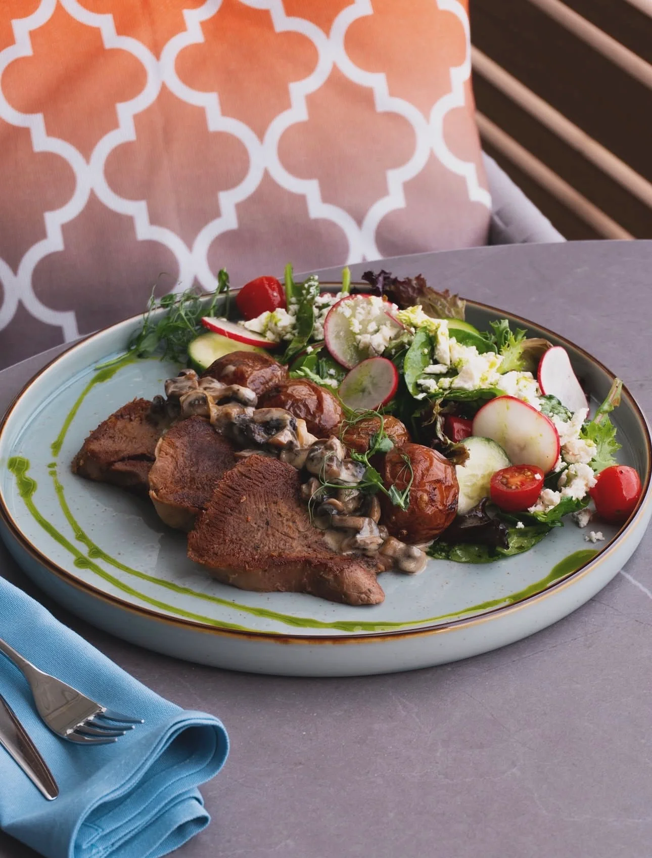 Grilled lamb chops with salad in a Mediterranean setting