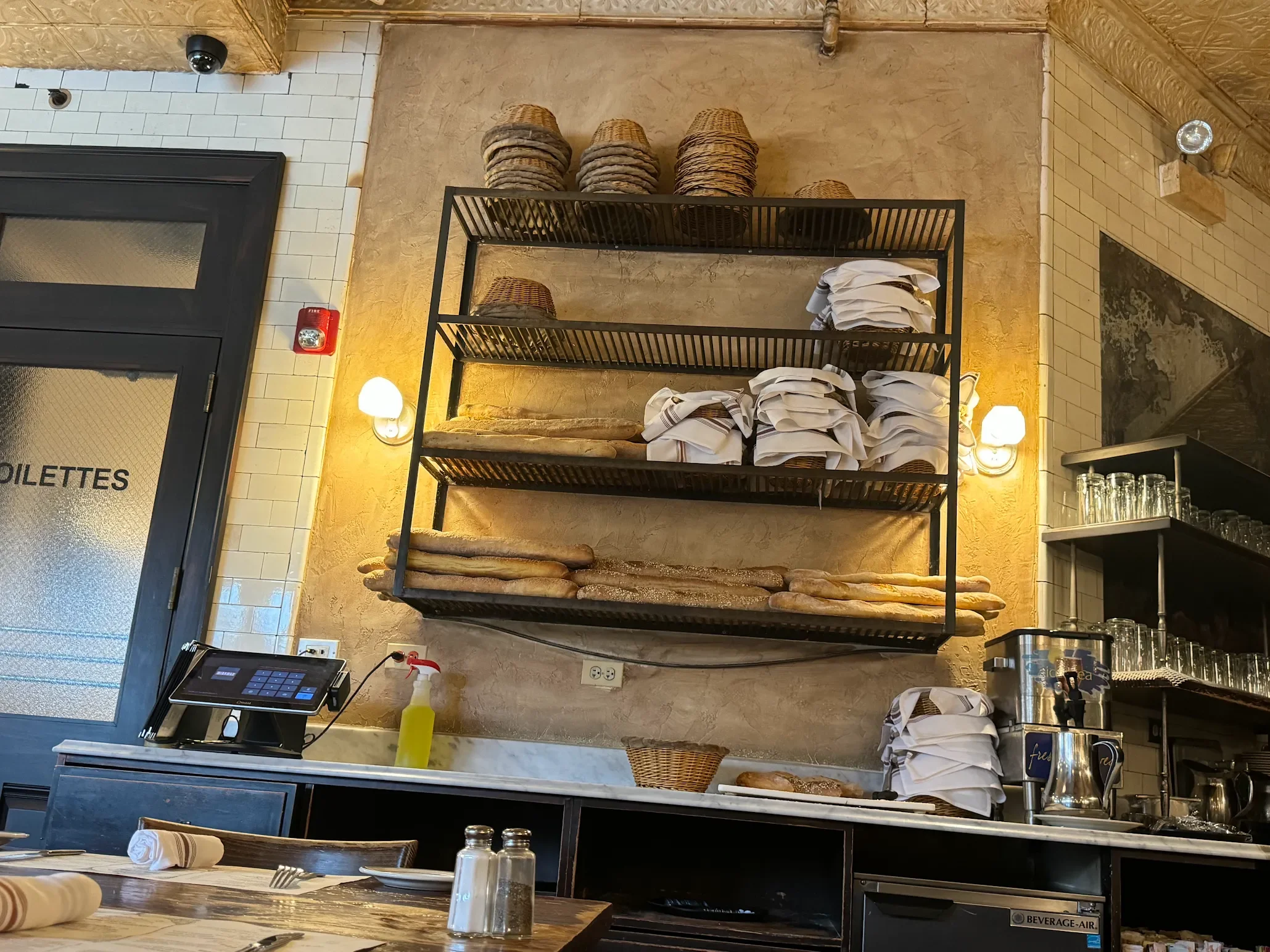 Cozy restaurant interior with shelves of bread and linens
