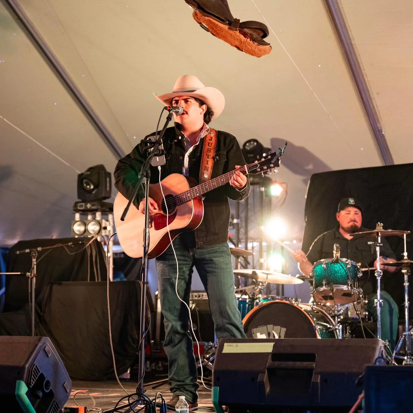 Live country music performance with guitar and drums