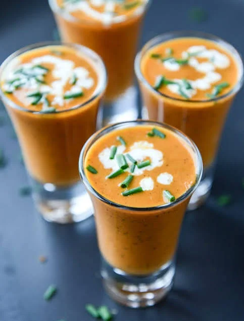 Chilled Indian spiced buttermilk shots garnished with herbs