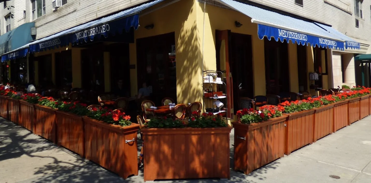 Charming Mediterranean restaurant exterior with flower boxes