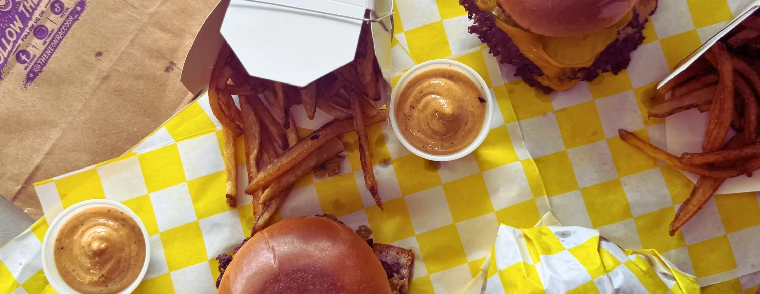 Juicy cheeseburger with fries and dipping sauce