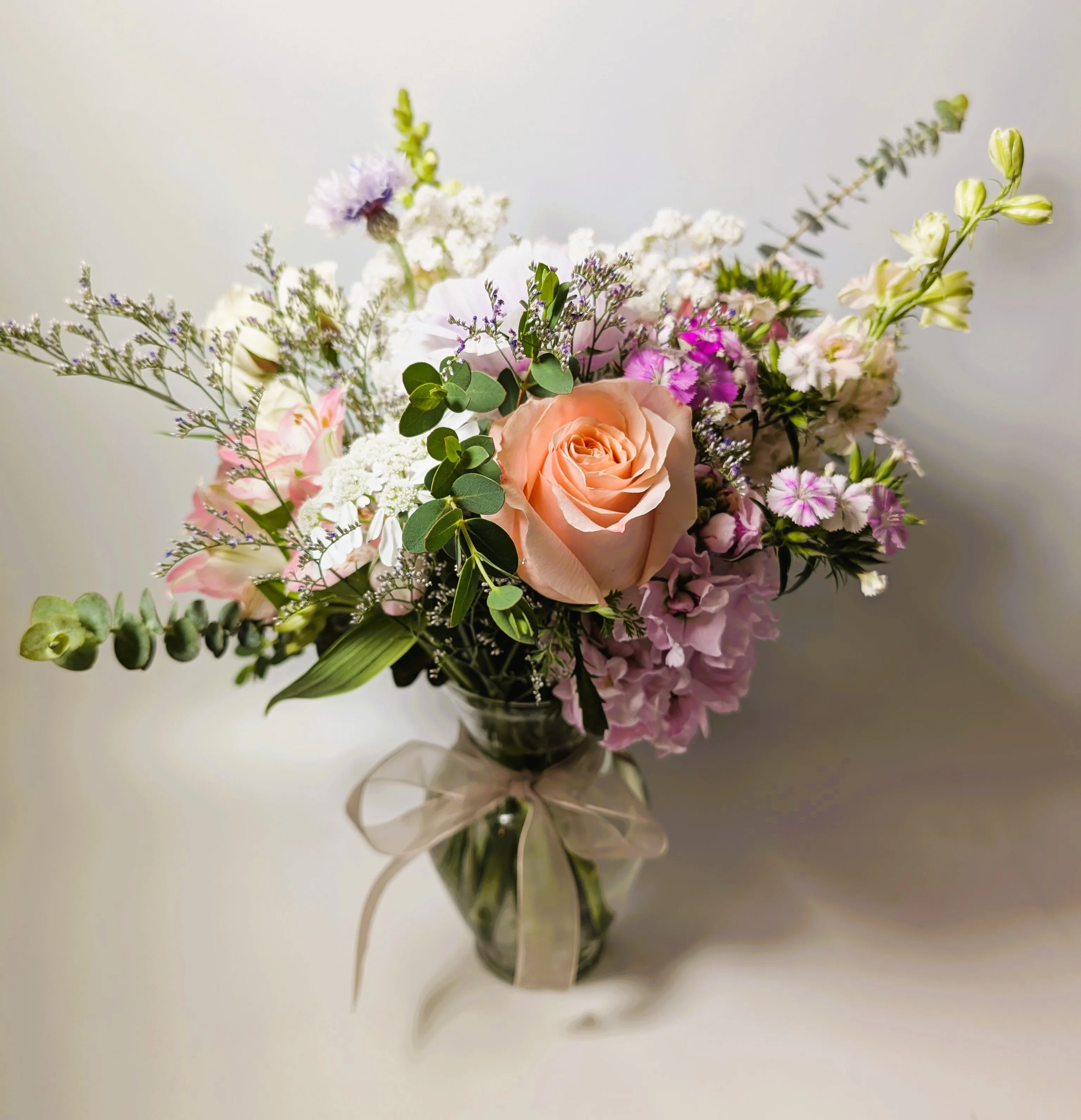 Beautiful floral arrangement with pastel roses and greenery