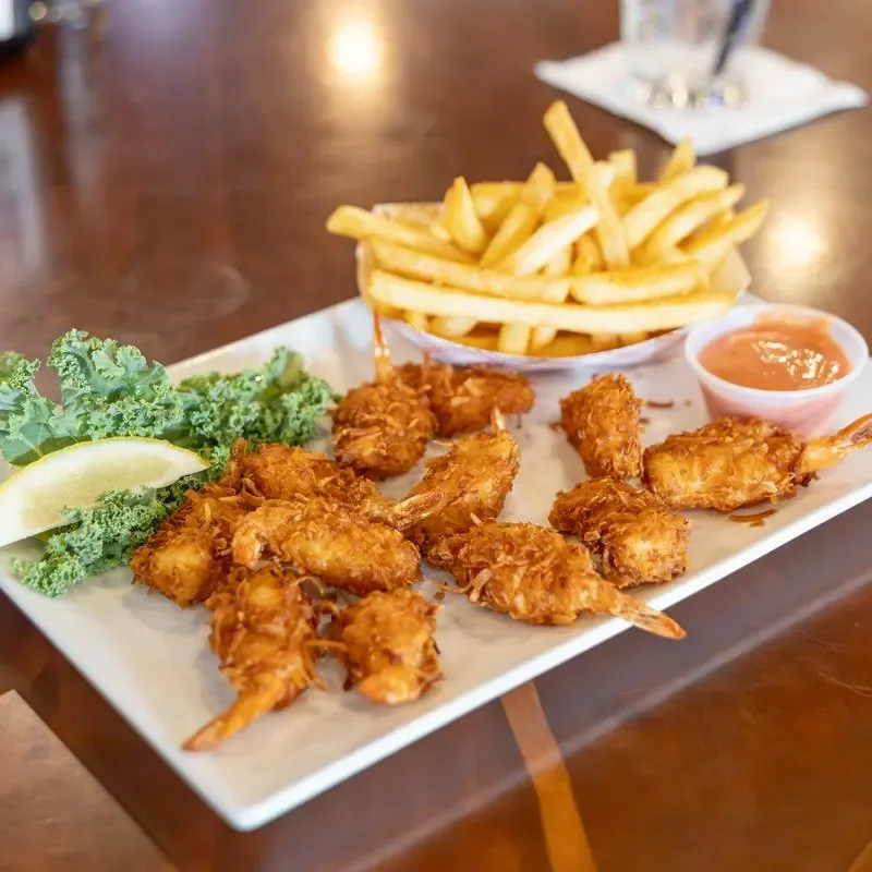 Coconut shrimp platter with fries and dipping sauce