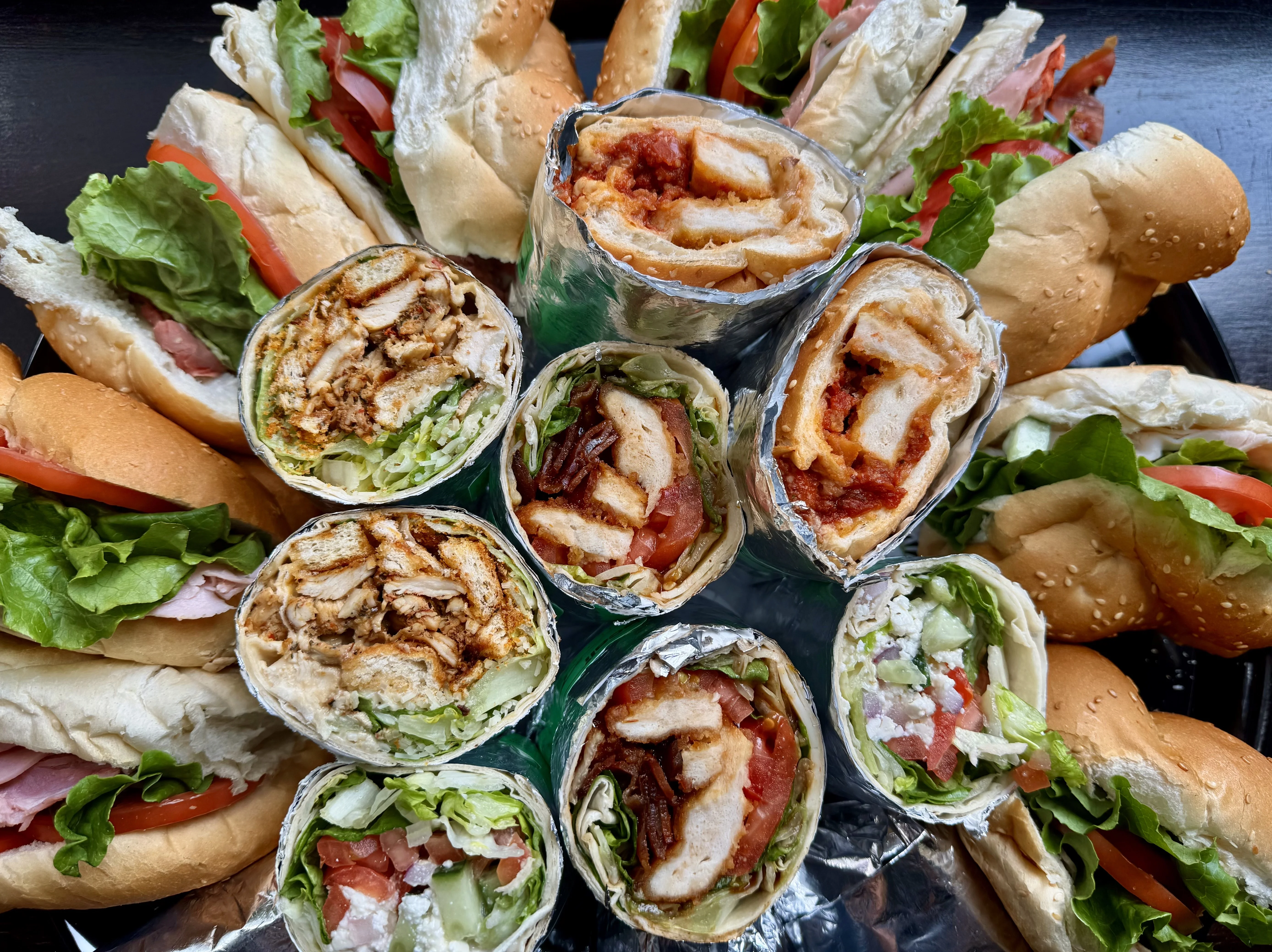 Assorted wraps and sandwiches on a platter