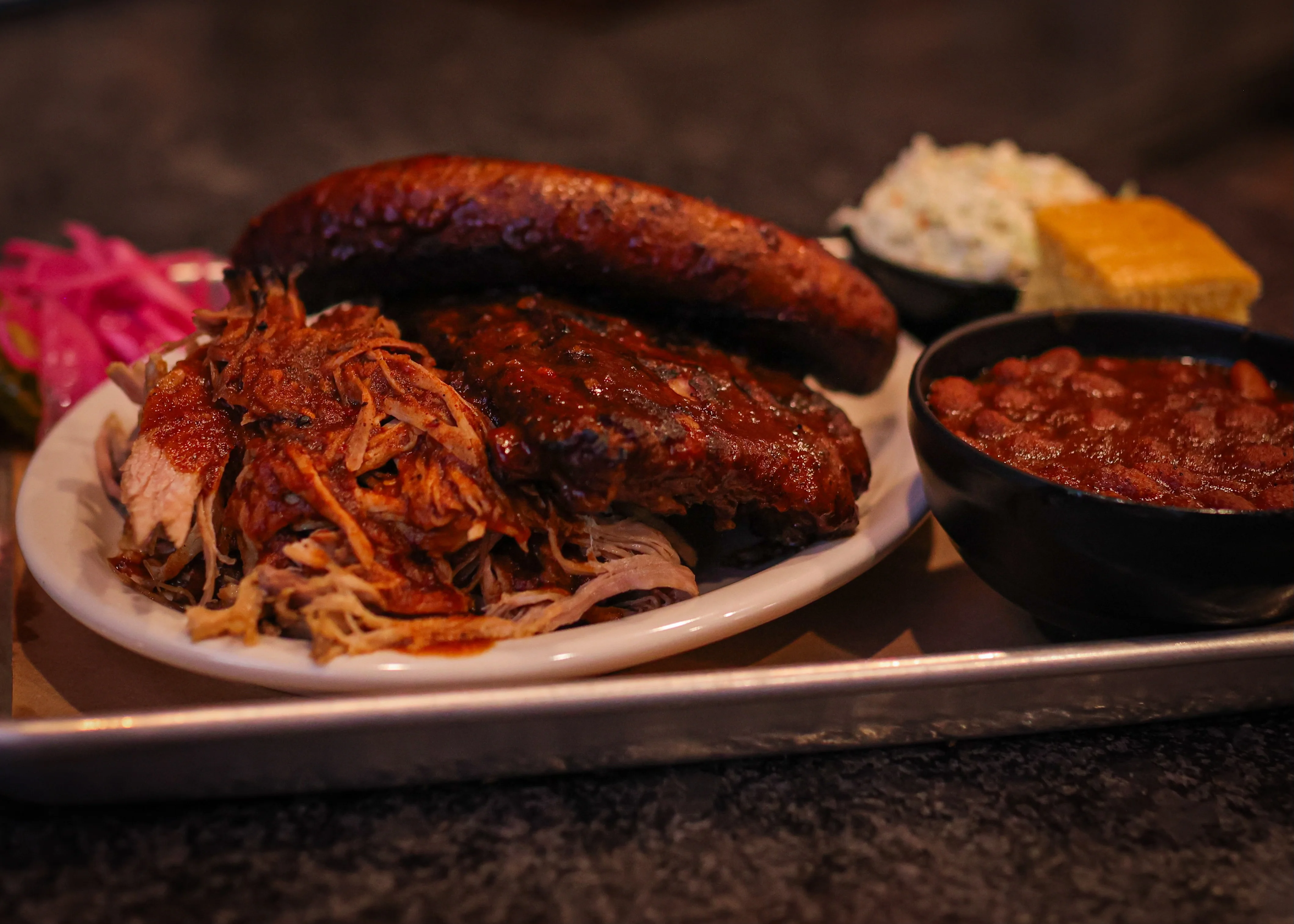 Platter of Texas-style barbecue with pulled pork and sausage