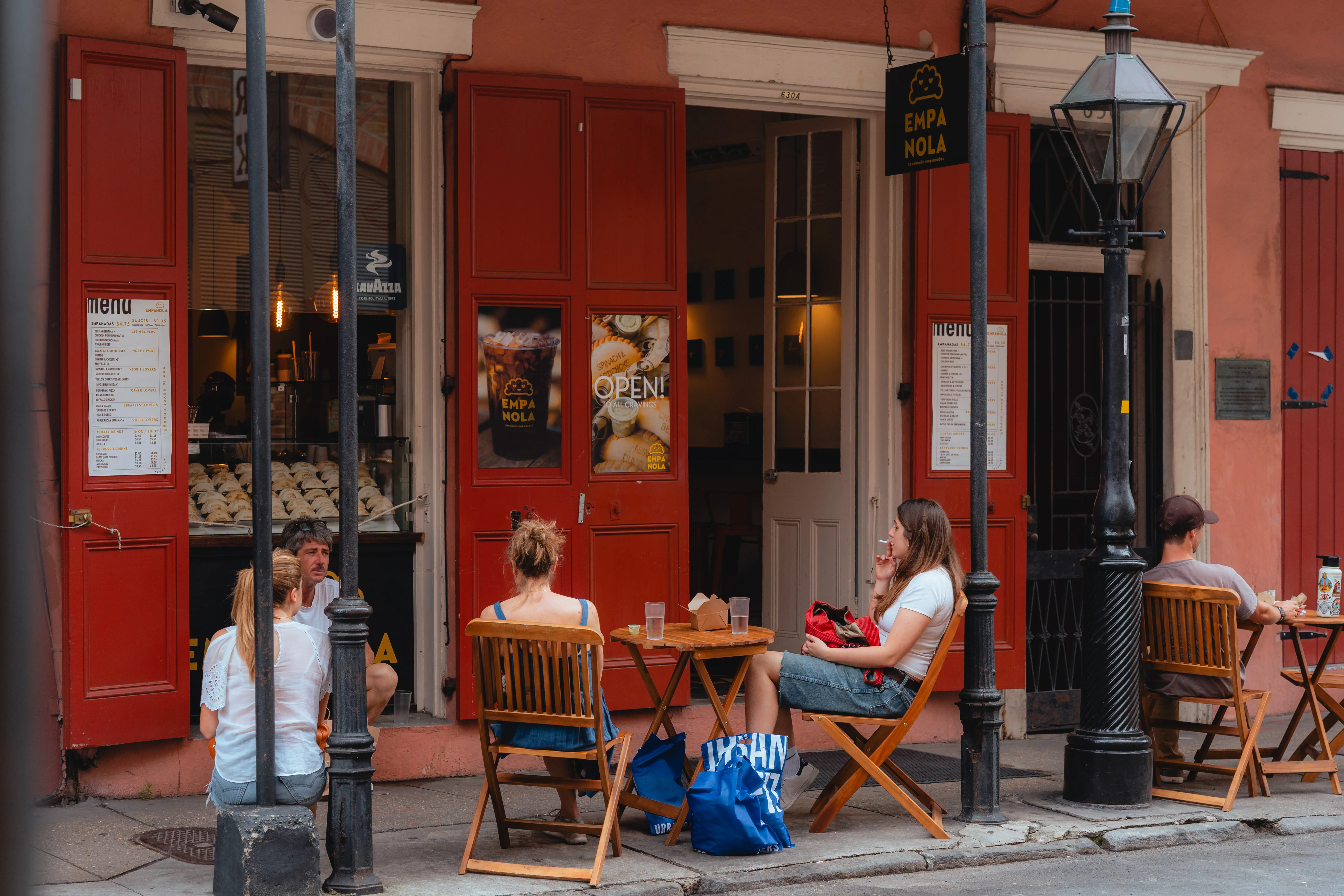 Outdoor dining at a cozy restaurant with red doors