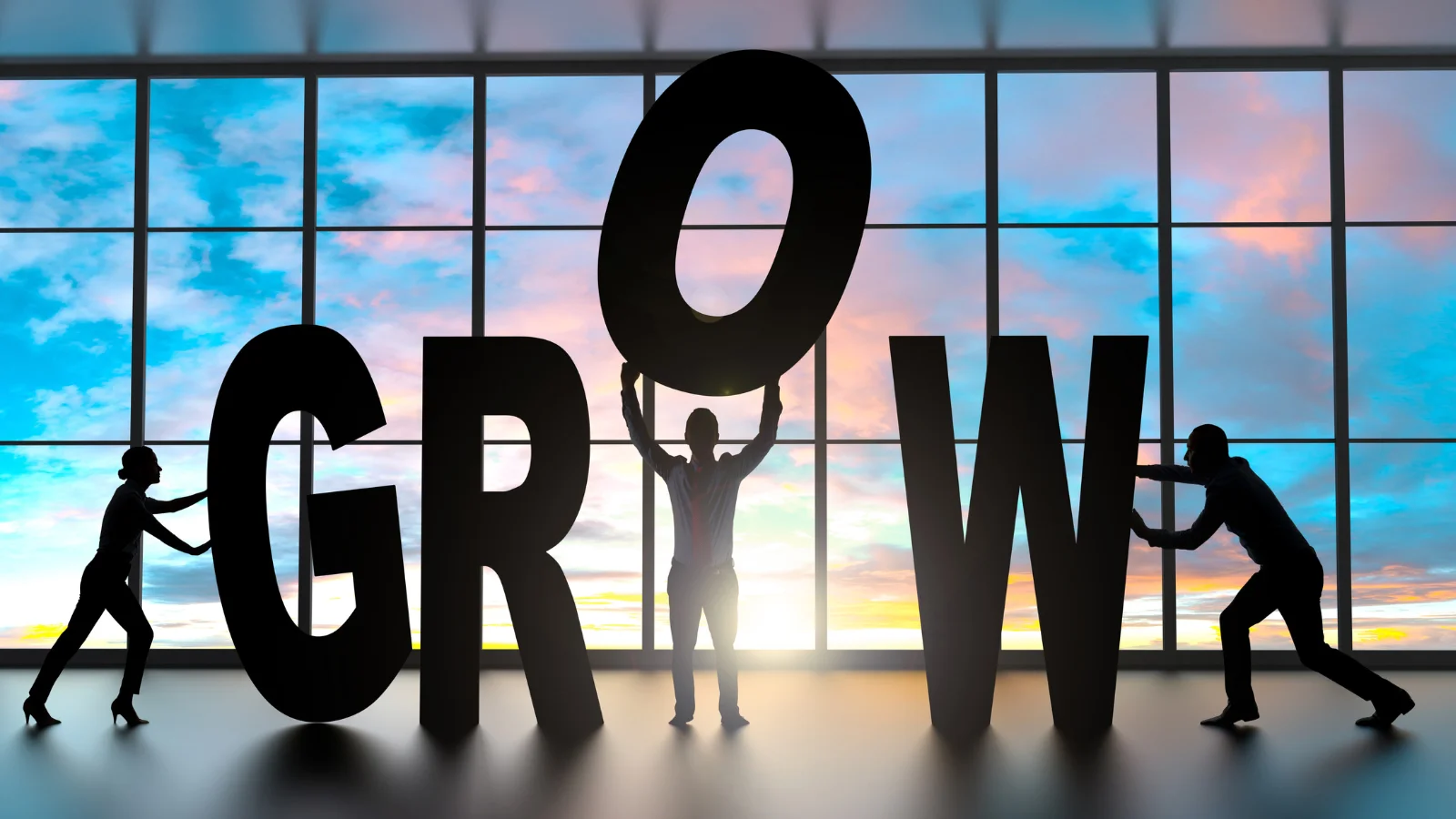 Silhouettes of people assembling the word 'GROW' against a colorful sunset