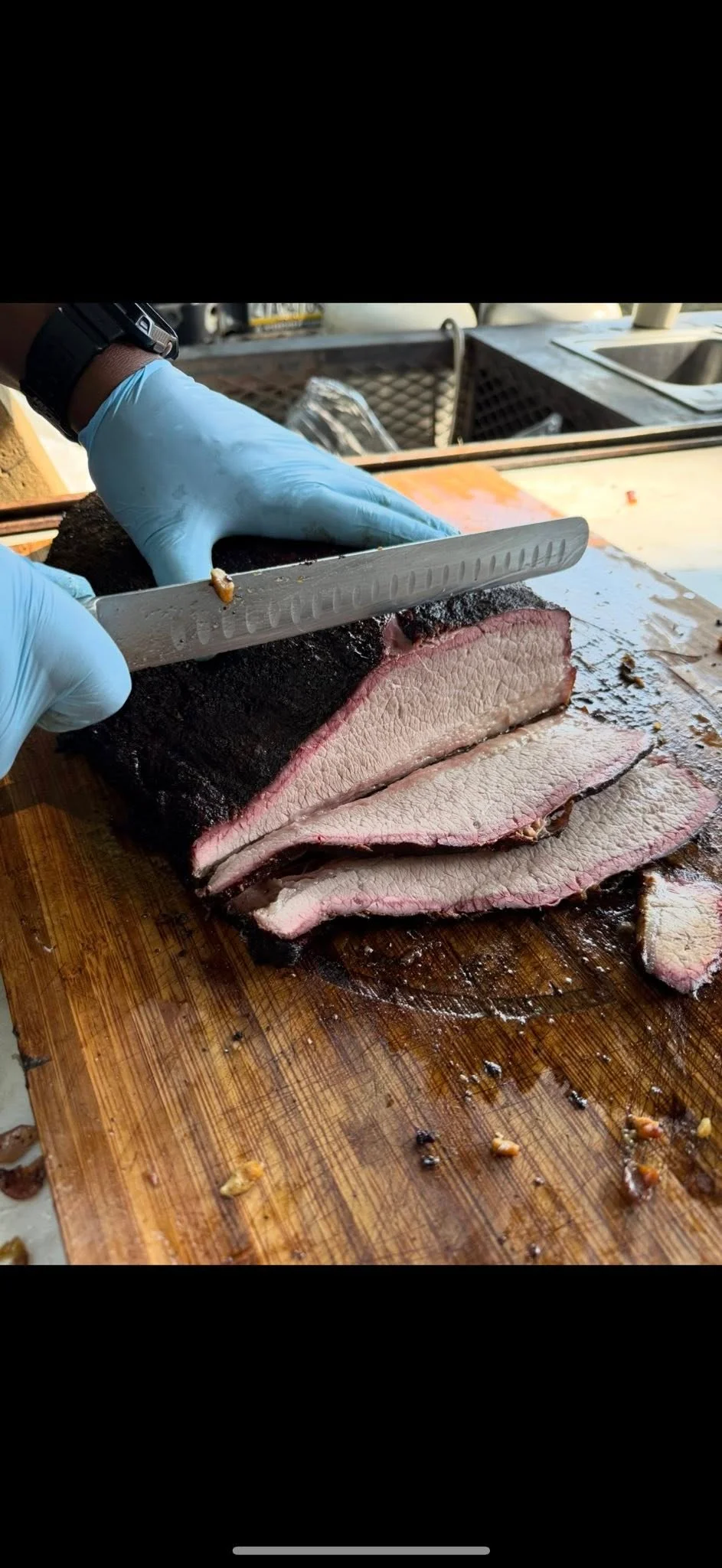 Sliced Texas-style brisket on a wooden cutting board